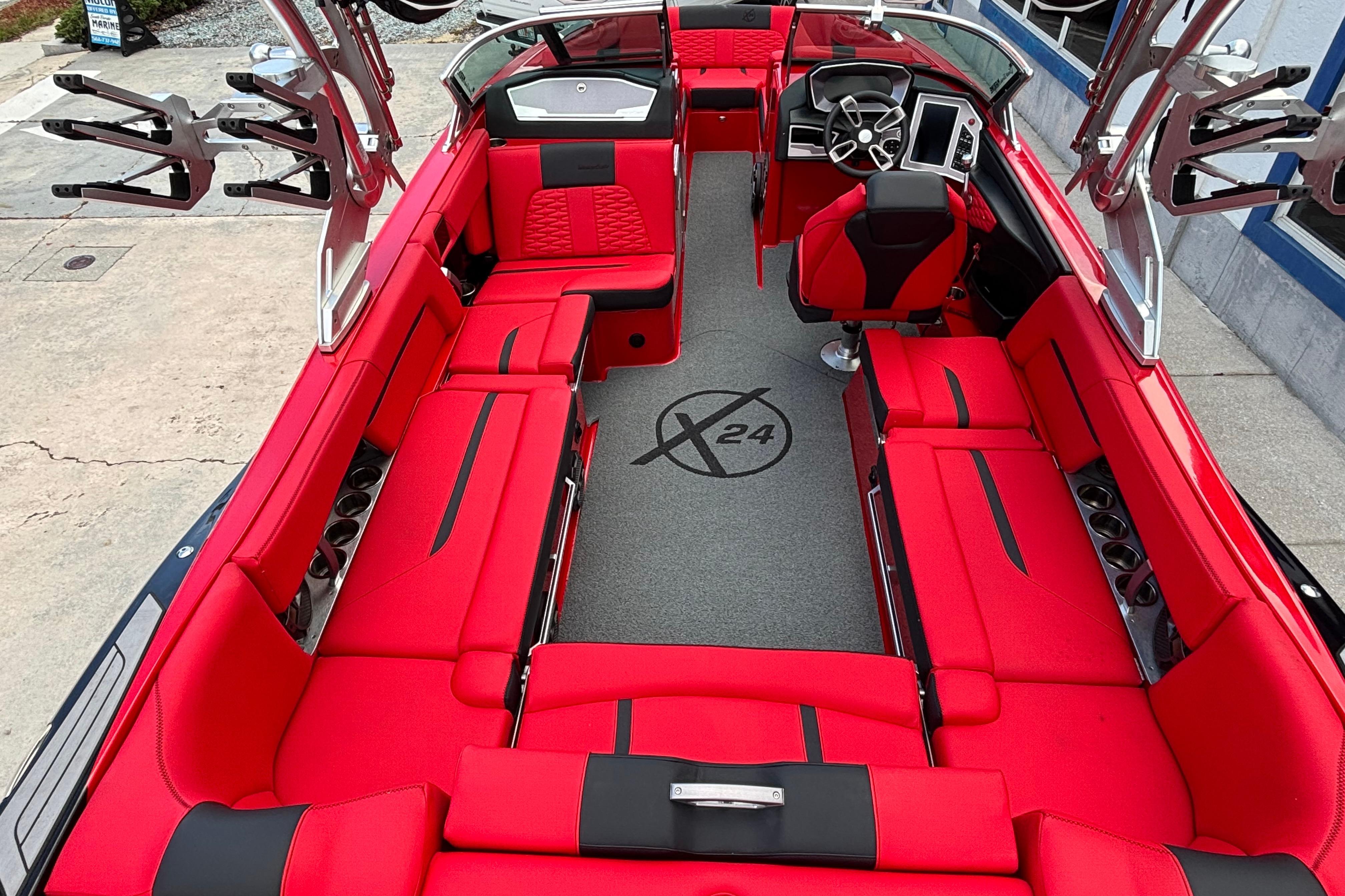 2020 MasterCraft X24 boat interior with vibrant red seating and modern dashboard.