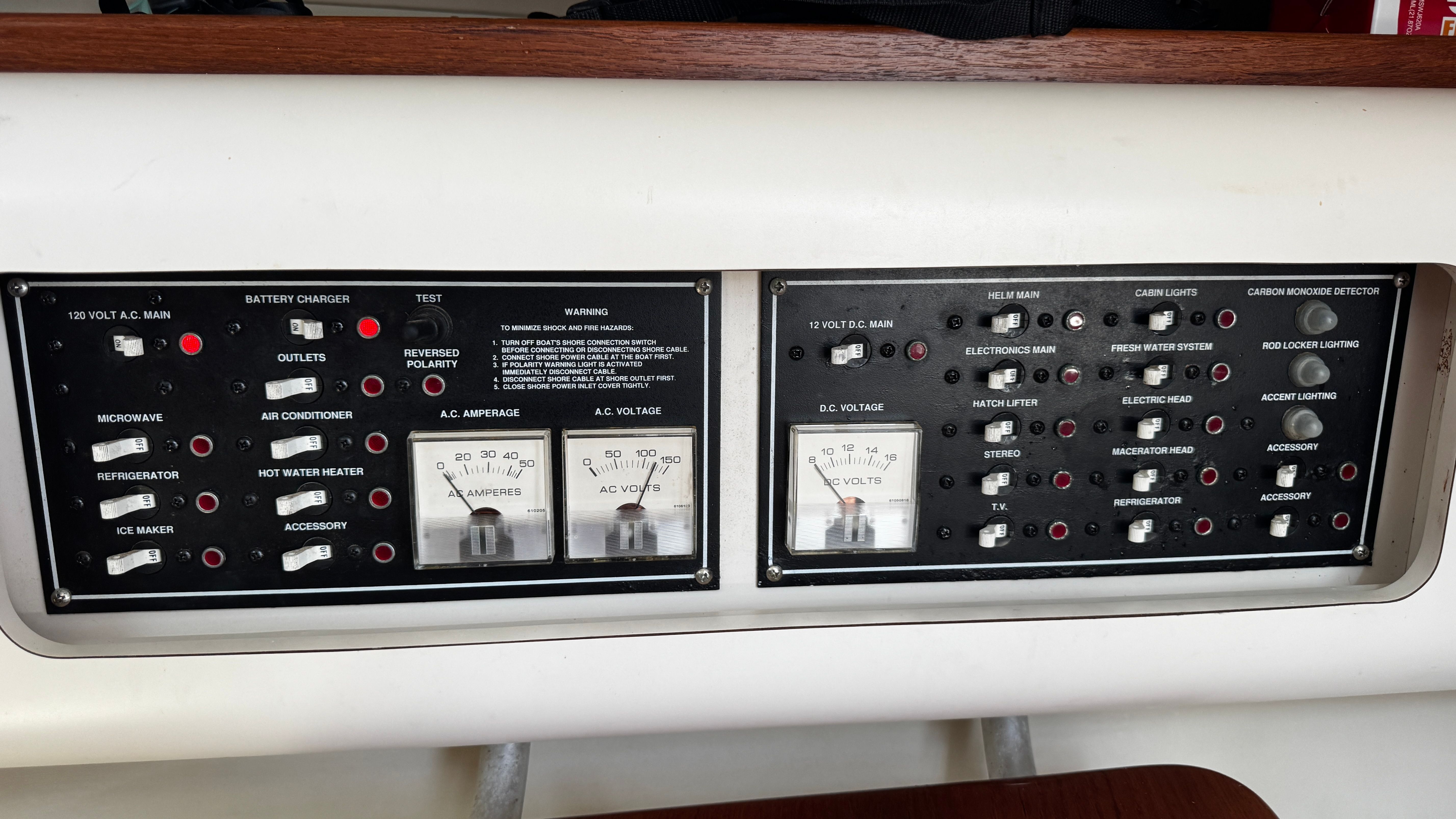 Control panel of a 2003 Pursuit 3070 with various switches and gauges.