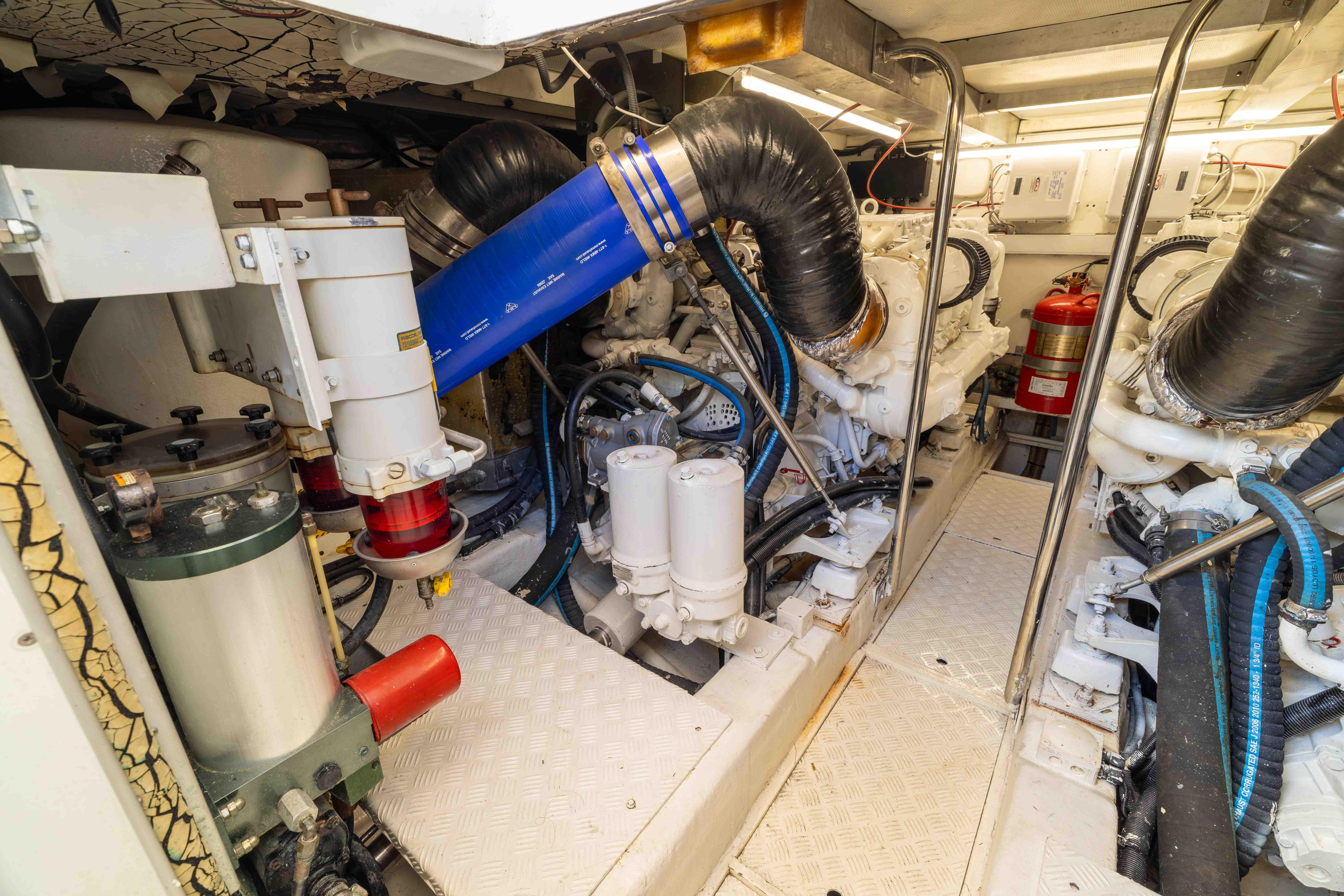 Engine room of a 2002 Princess 61 yacht, showcasing machinery and equipment.
