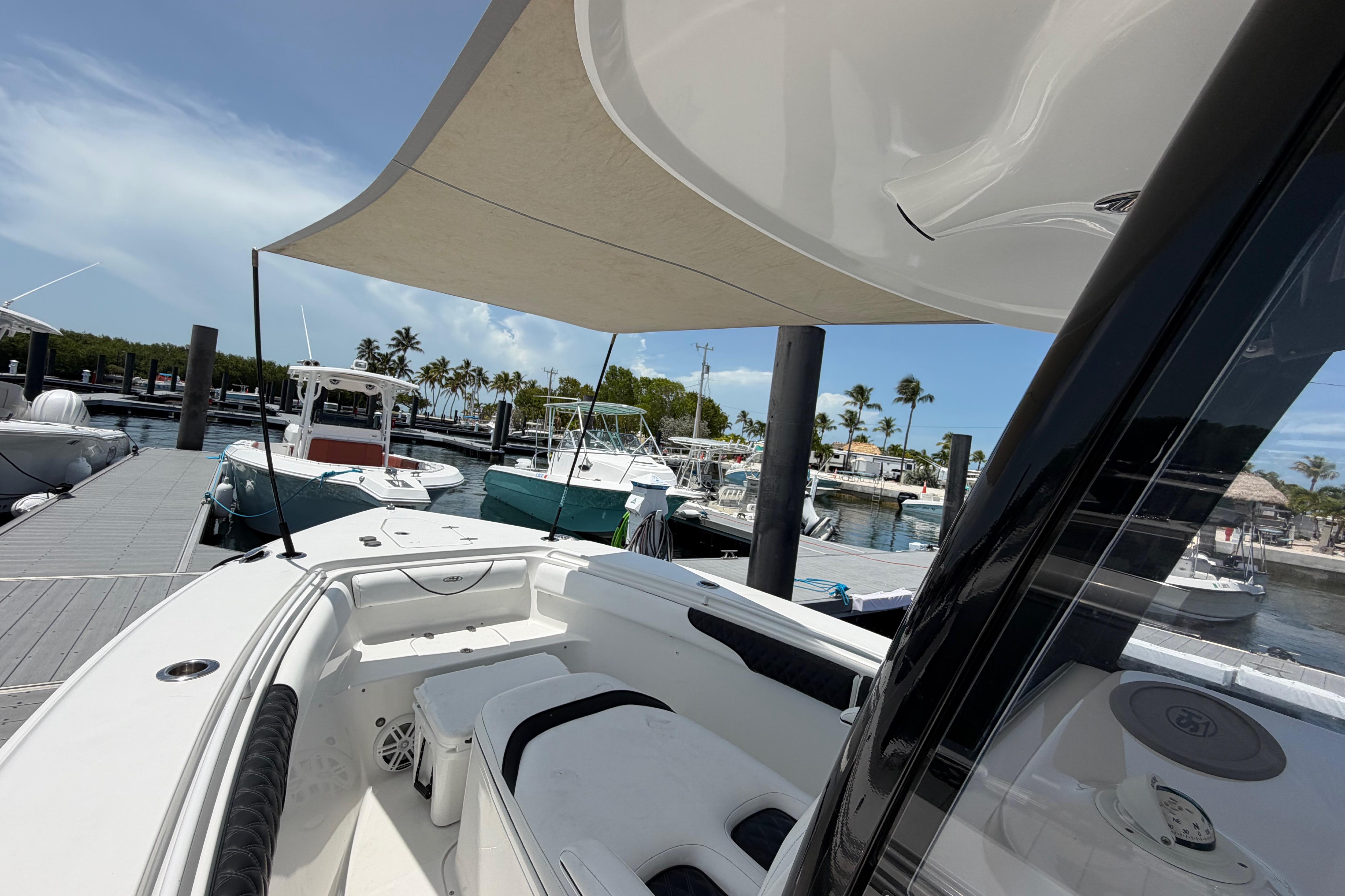 2019 Sea Hunt Gamefish 27 Coffin Box docked at marina under sunny skies.