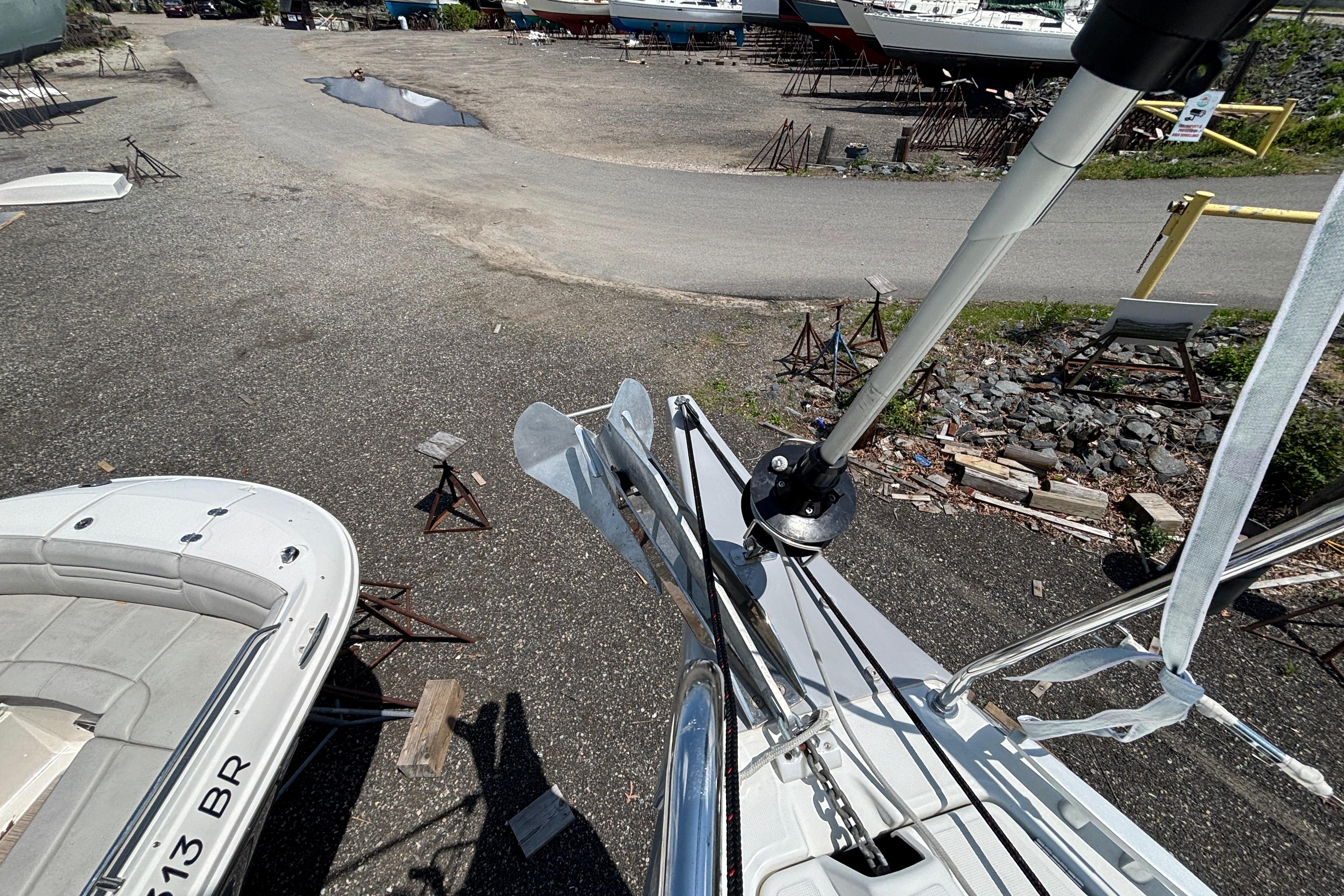 Beneteau Oceanis 30.1 sailboat on land, 2021 model, with visible anchor and mast.