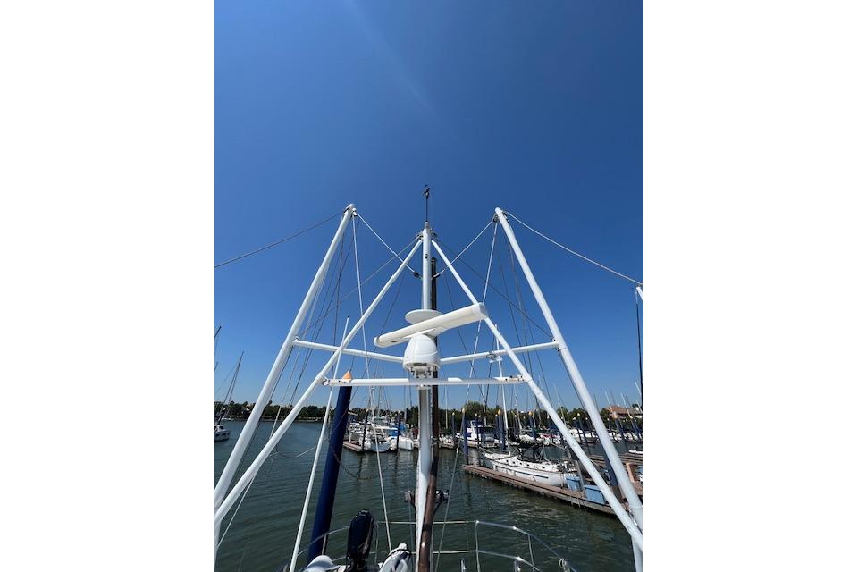 1998 Nordhavn 46 yacht mast and rigging against clear blue sky in marina.