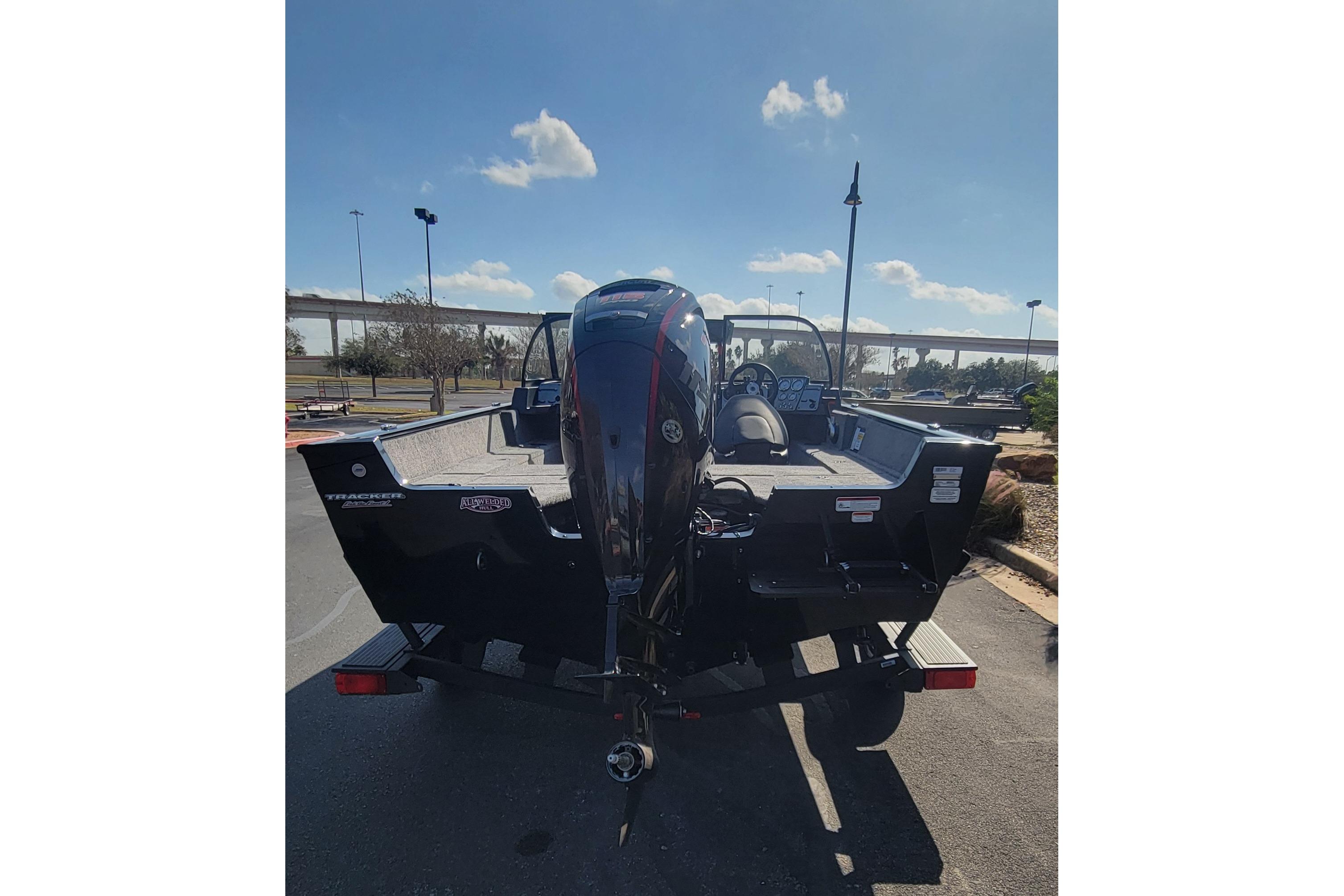 2026 Tracker Pro Guide V-175 Combo boat, rear view with motor, parked outdoors.