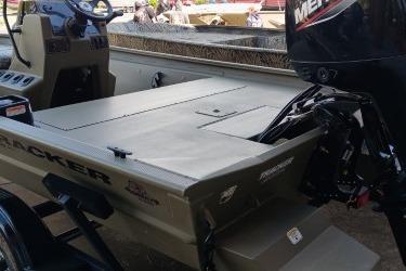 2026 Tracker Grizzly 1860 CC boat with outboard motor, docked outdoors.