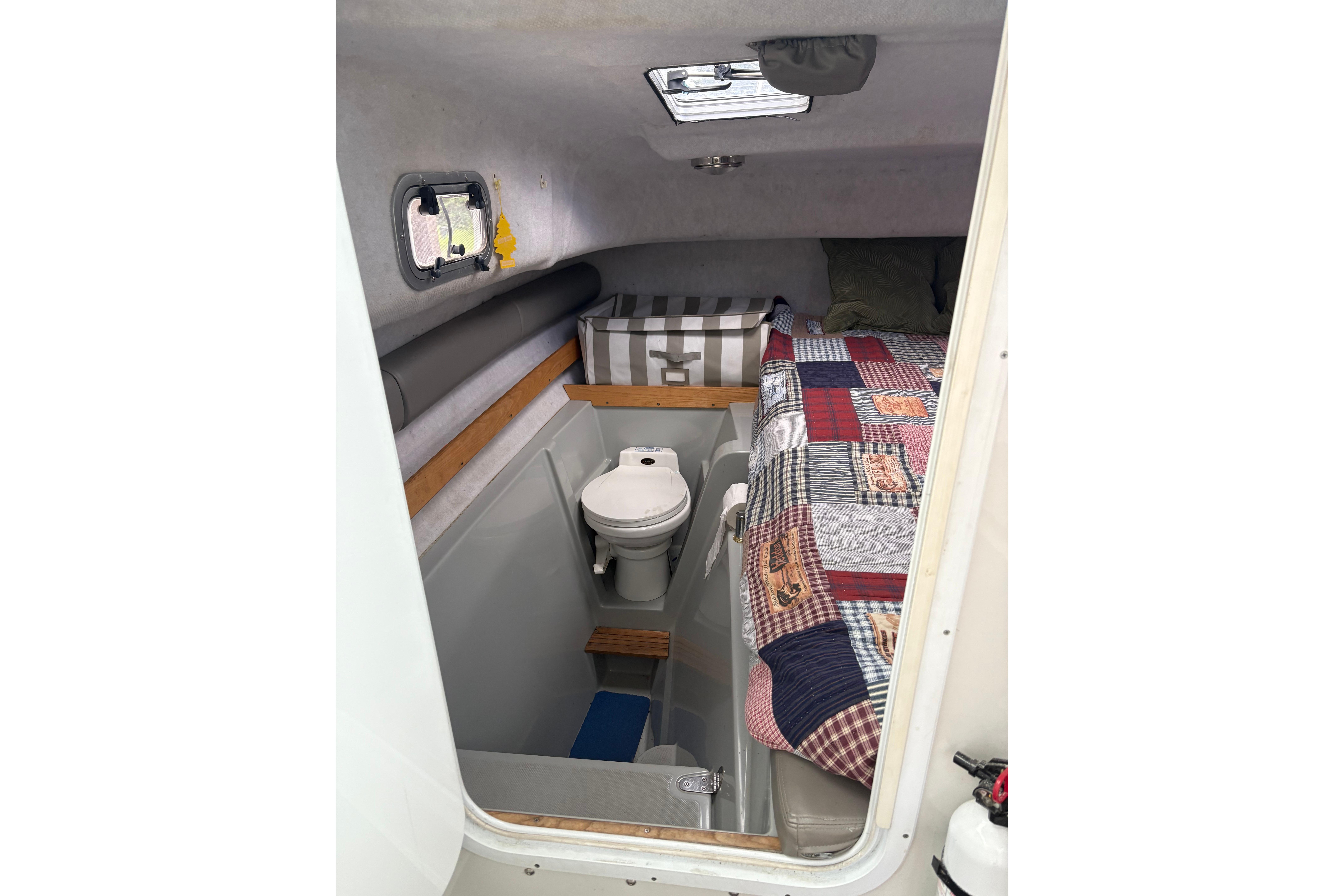 2001 Glacier Bay 2690 Coastal Runner cabin with bed and toilet.
