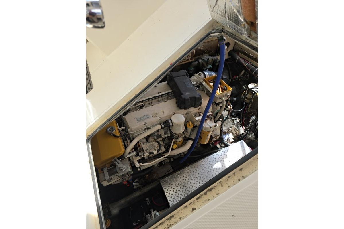 Engine compartment of a 1999 Albemarle 305 Express Fisherman boat, showcasing mechanical components.