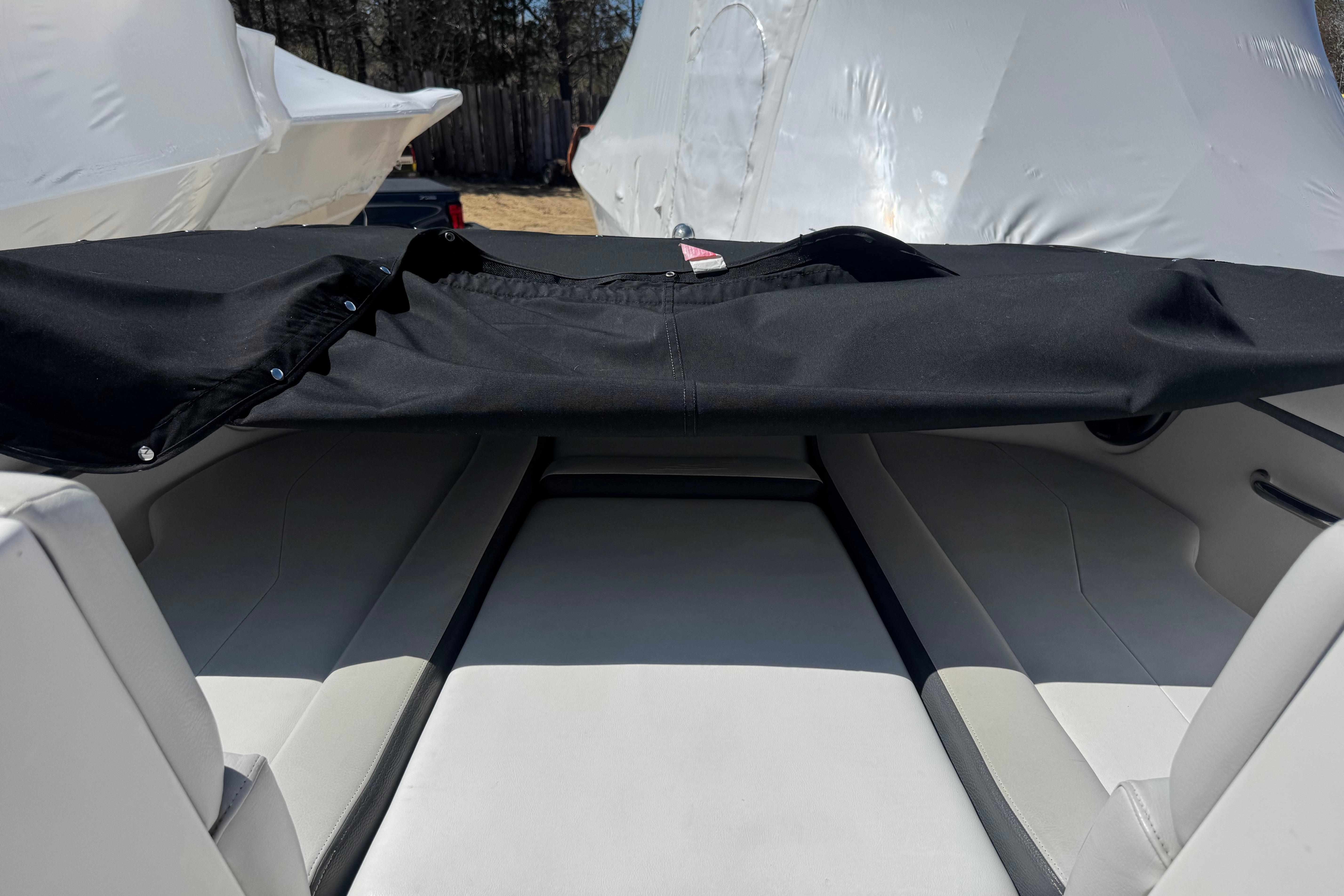 2017 Regal 23 OBX boat interior with black cover, showcasing seating area.