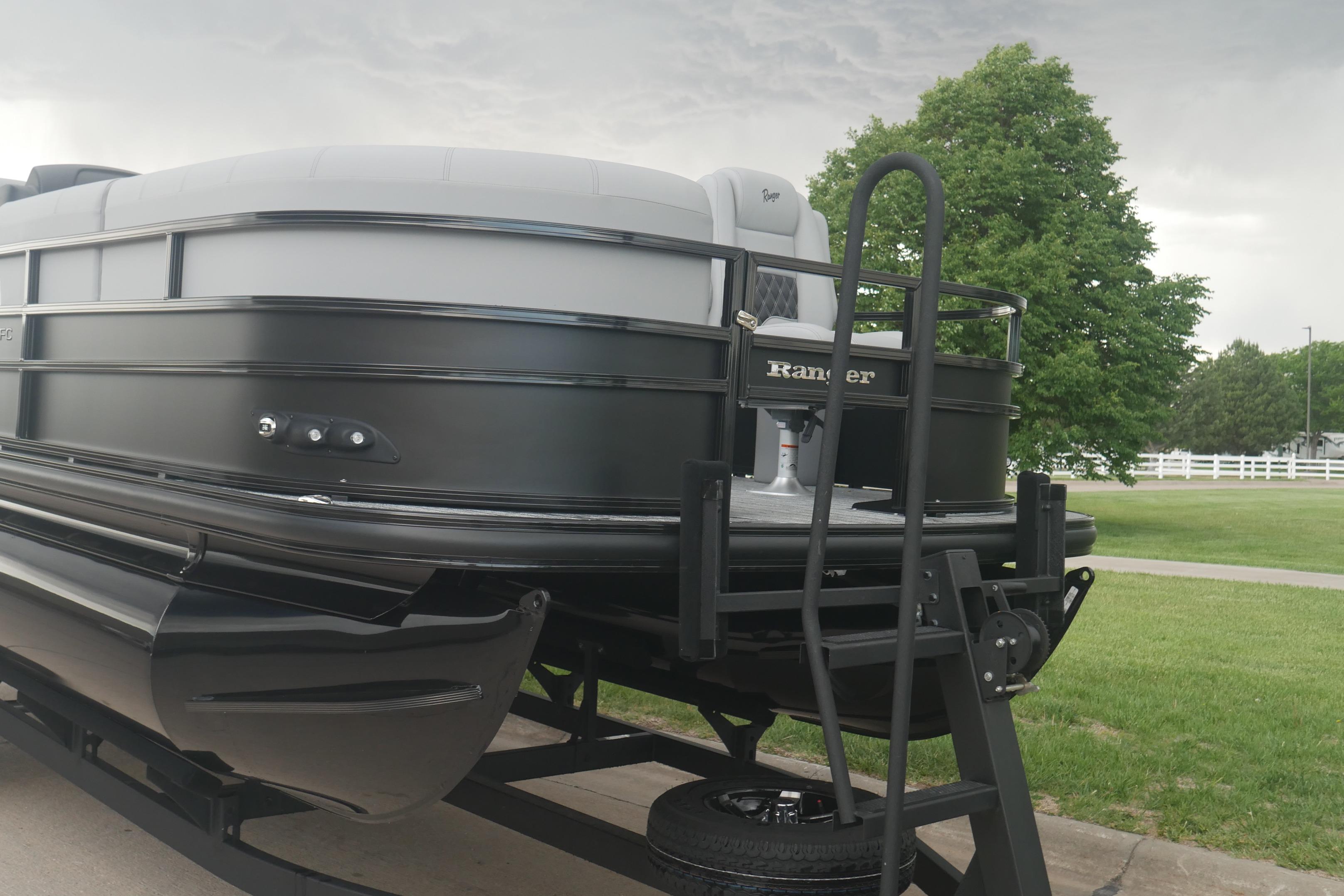 2026 Ranger 220FC pontoon boat on trailer, parked on grassy area.
