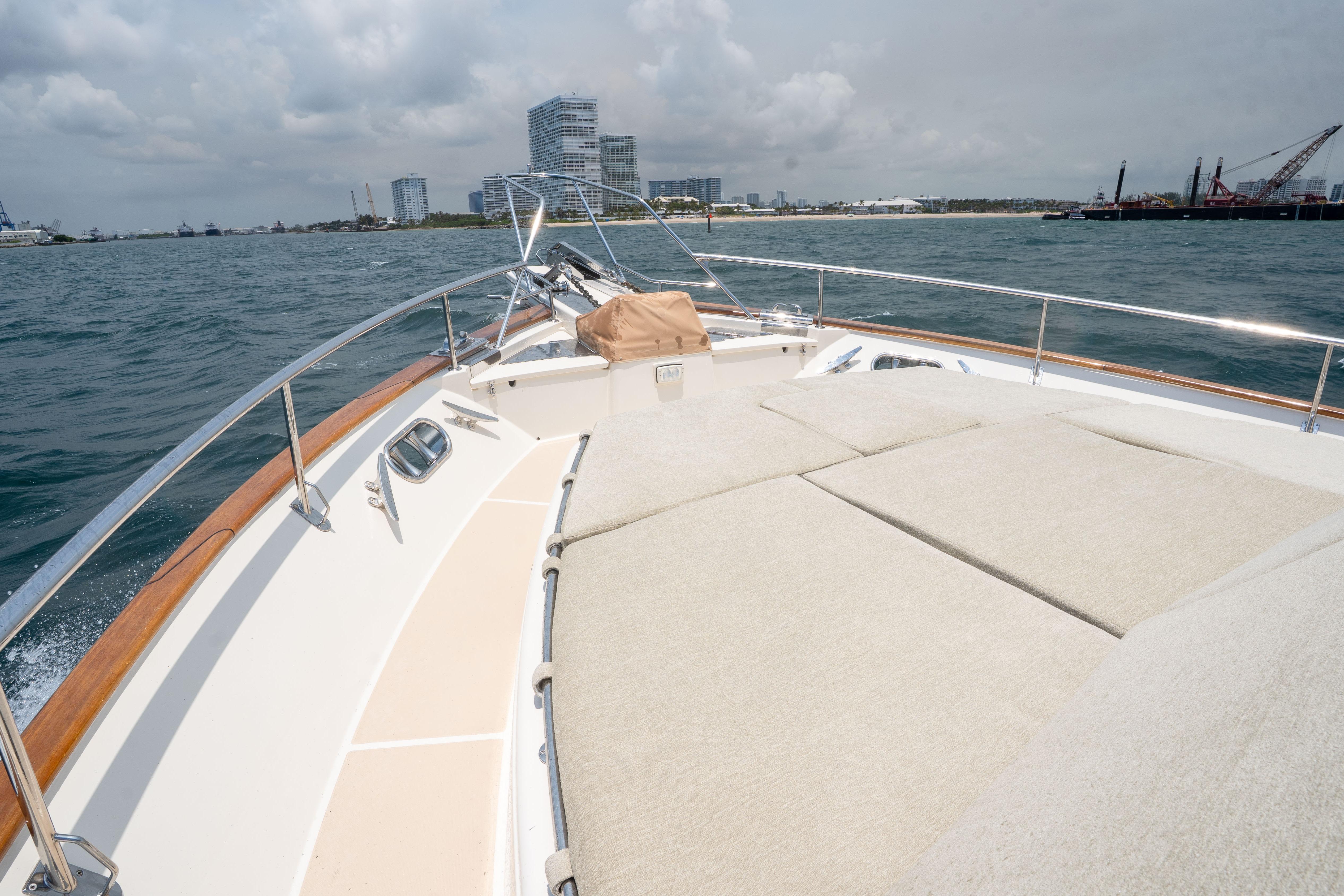 Bow view of 2006 Fleming 75 yacht cruising near city skyline.