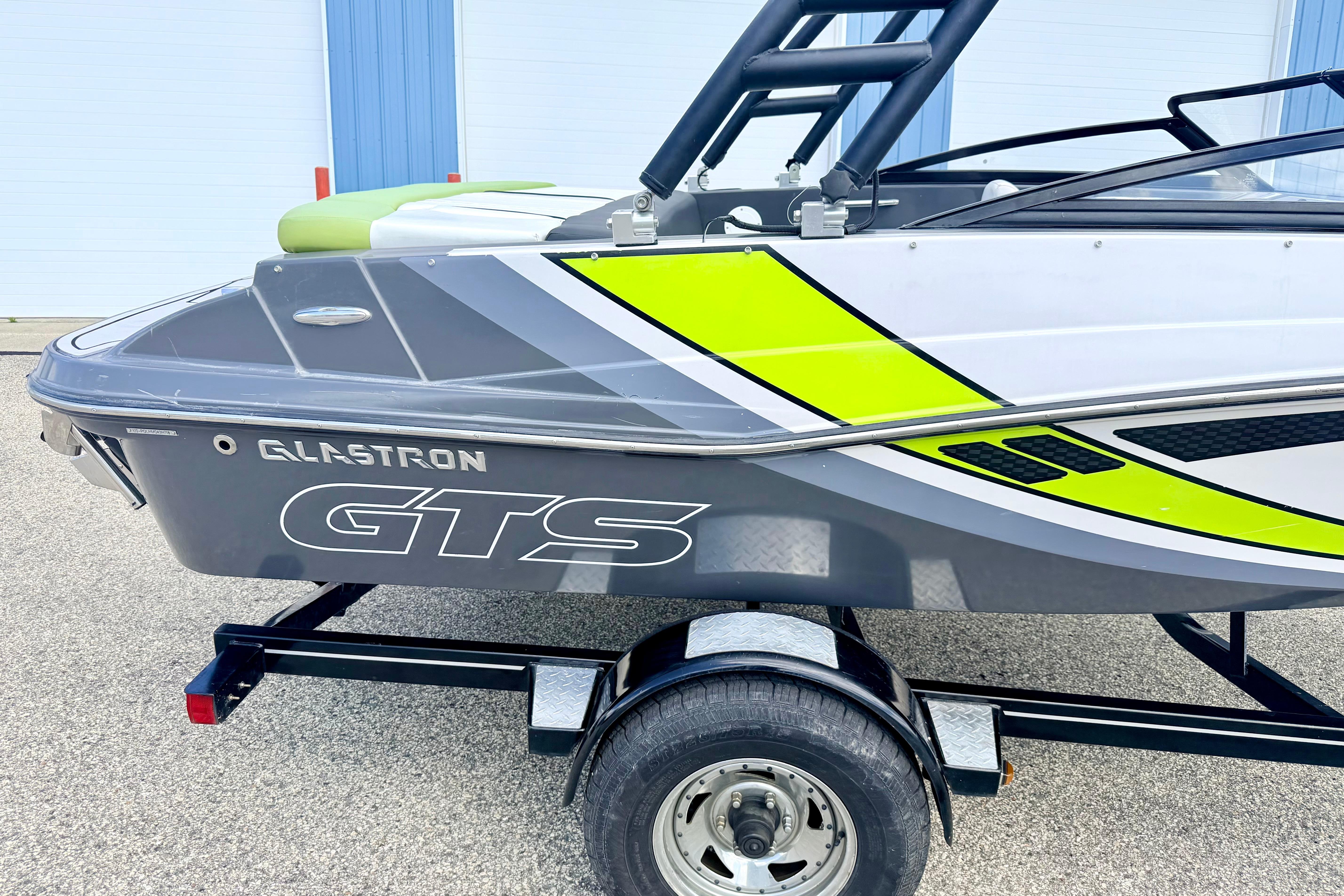 2018 Glastron GT 185 boat with vibrant graphics on a trailer.