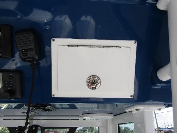 2024 Wellcraft 263 Fisherman boat console with storage compartment and communication equipment.