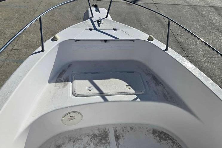 2001 Pro-Line 19 Sport boat bow with storage compartment and railing.