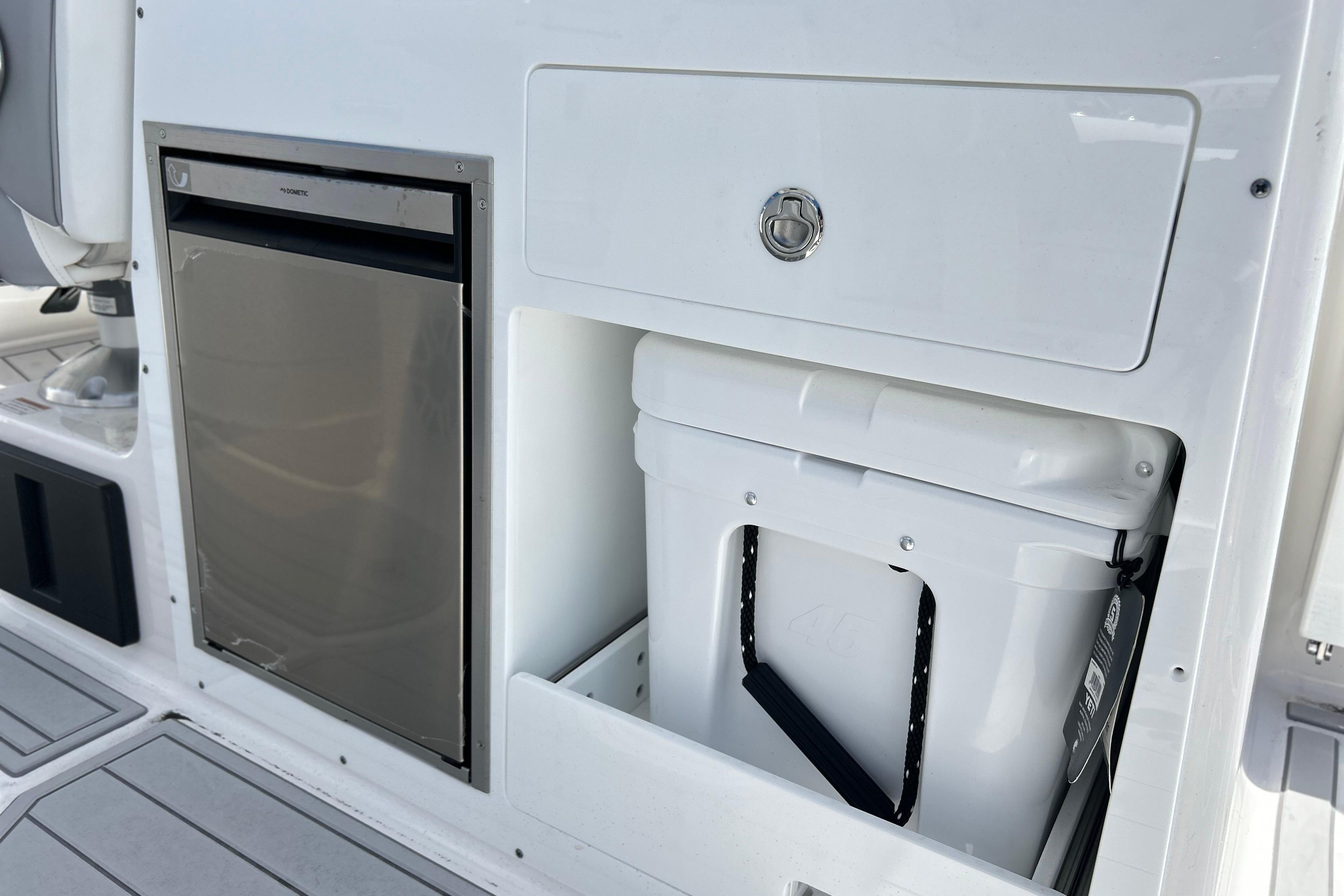 2026 Sea Fox 288 Traveler boat interior with fridge and storage compartment.