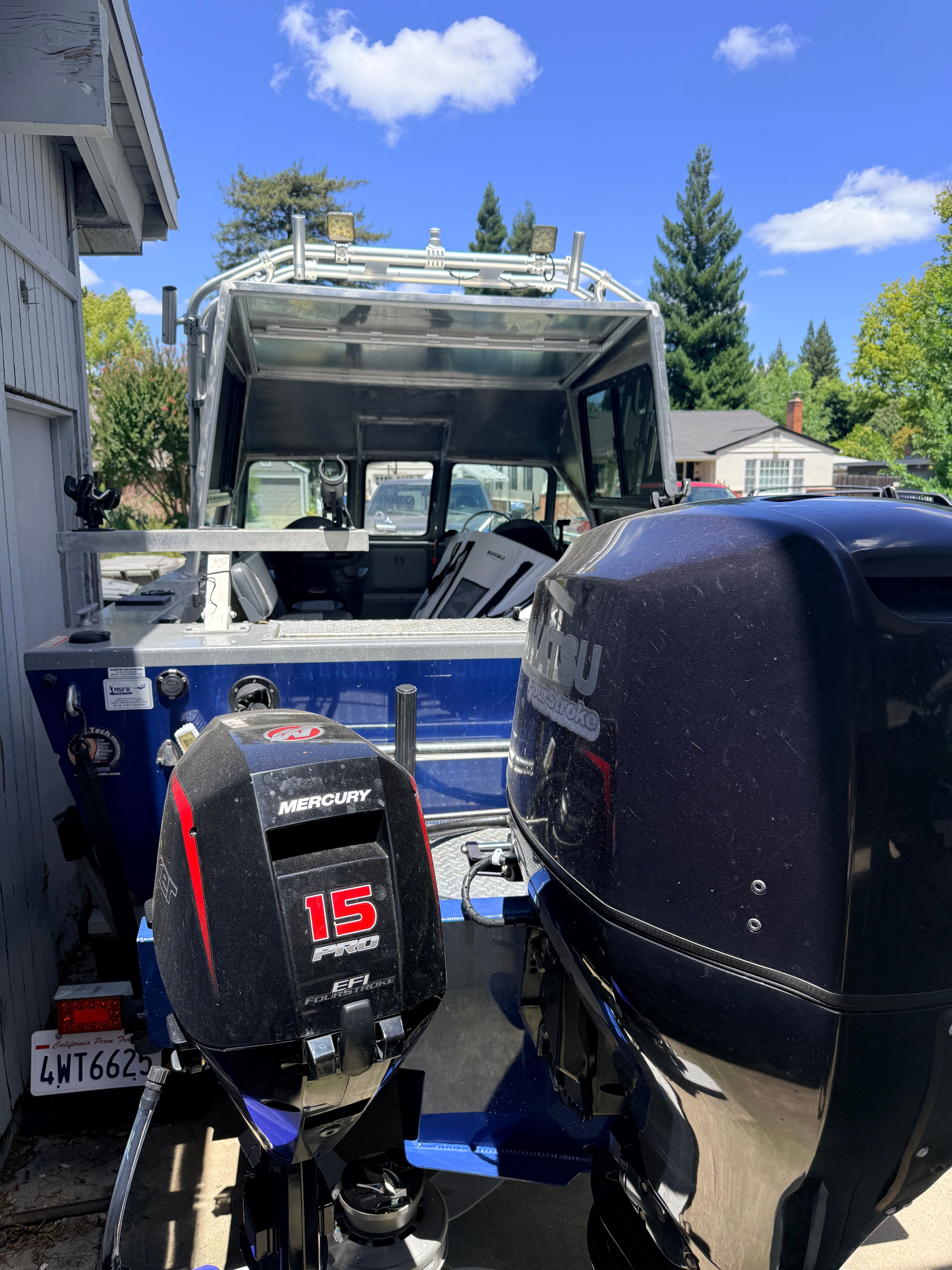 A 2017 River Hawk Coastal Series 20’ boat with two outboard motors.