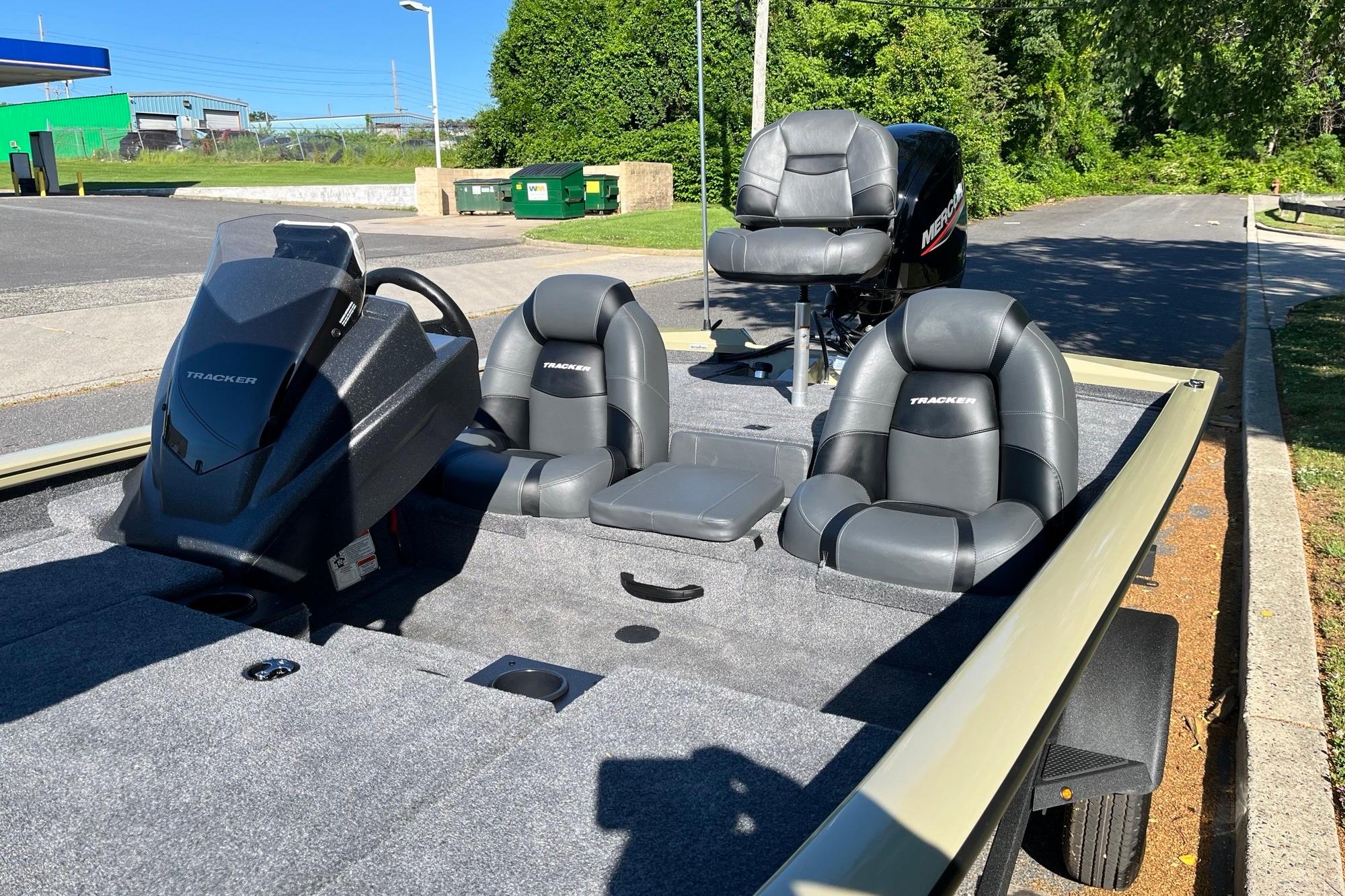 2026 Tracker Pro Team 175 boat with seating and steering console in a sunny outdoor setting.