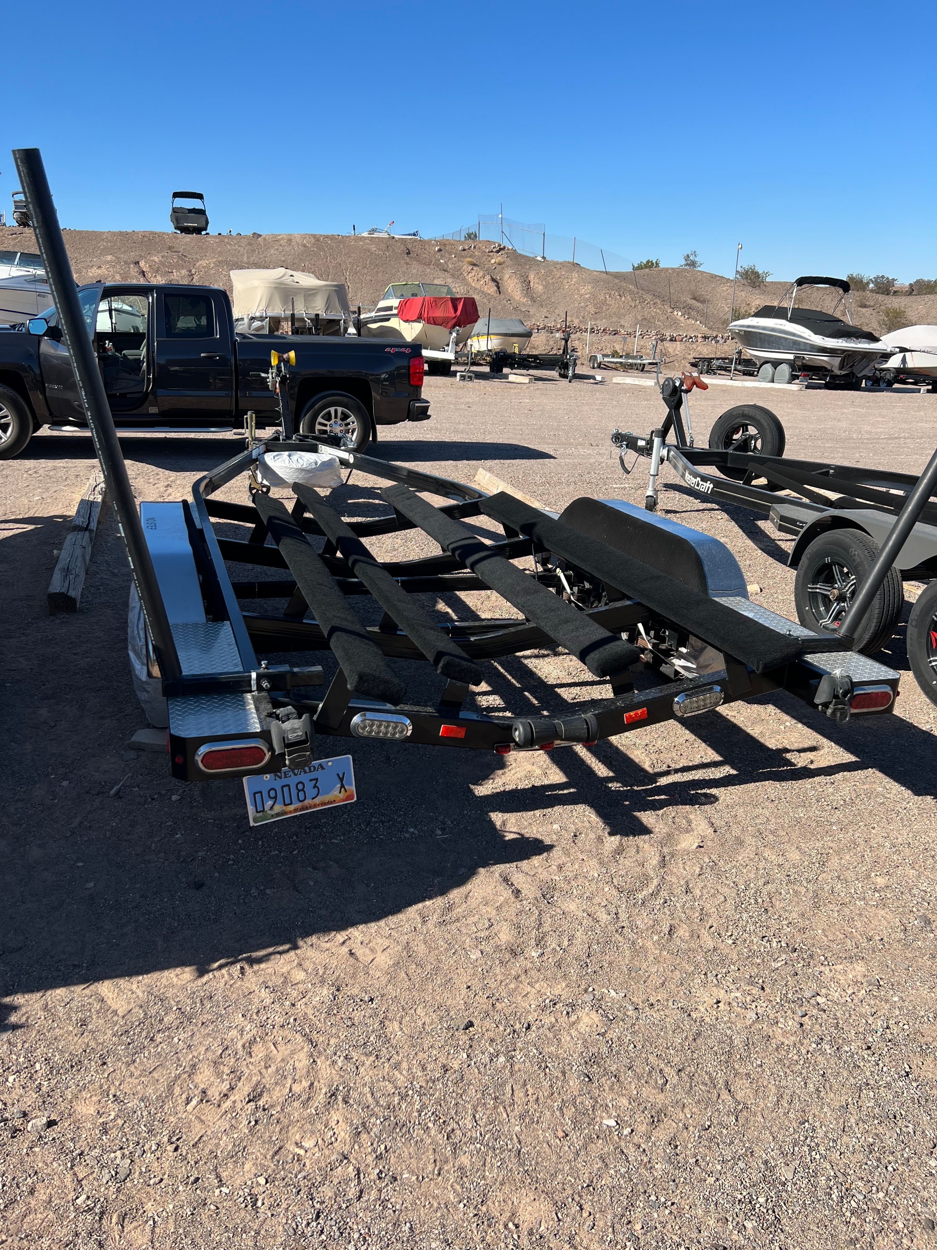 Boat trailer on gravel lot, Cobalt 232, year 2012.