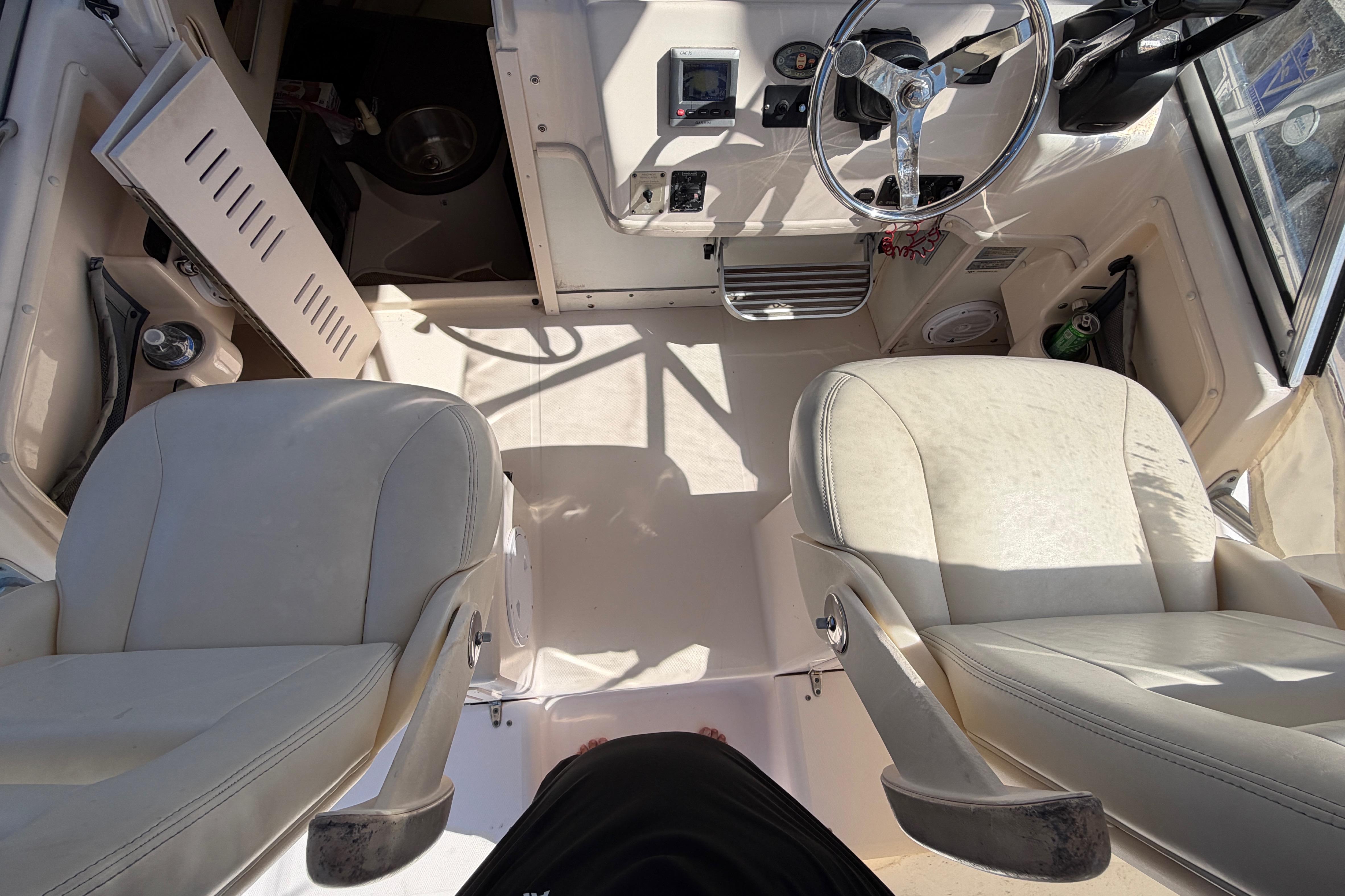 Interior view of 2006 Grady-White Sailfish 282 boat cockpit with steering wheel and seats.