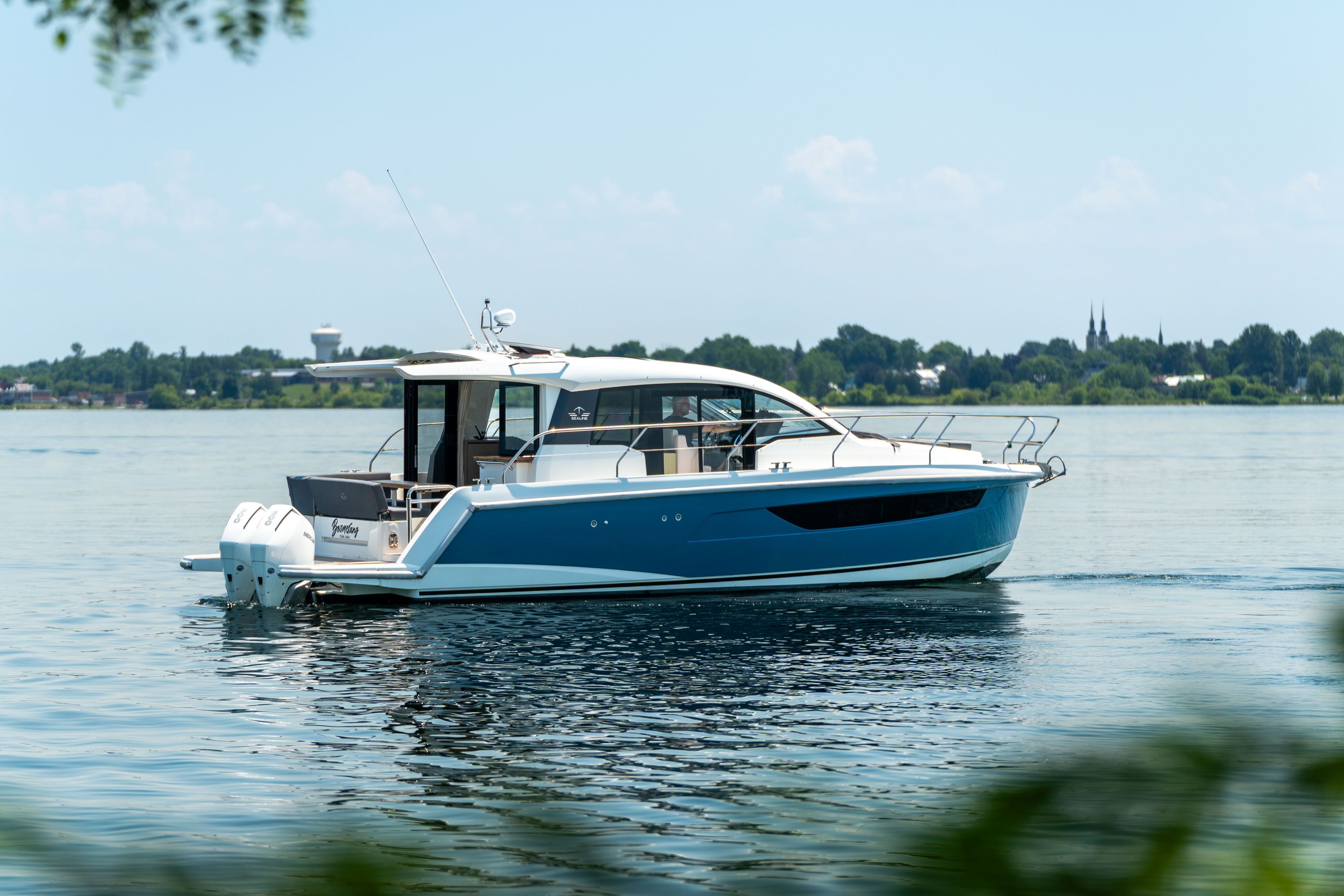 Sealine C335V 2023 on calm water with a modern cabin and outboard engines.