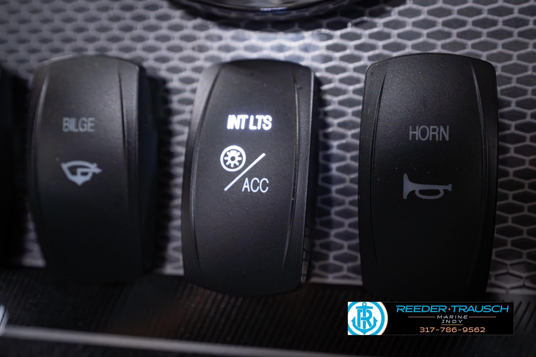 Dashboard switches of 2026 Lund 1650 Rebel XL SS boat, featuring bilge, interior lights, and horn controls.