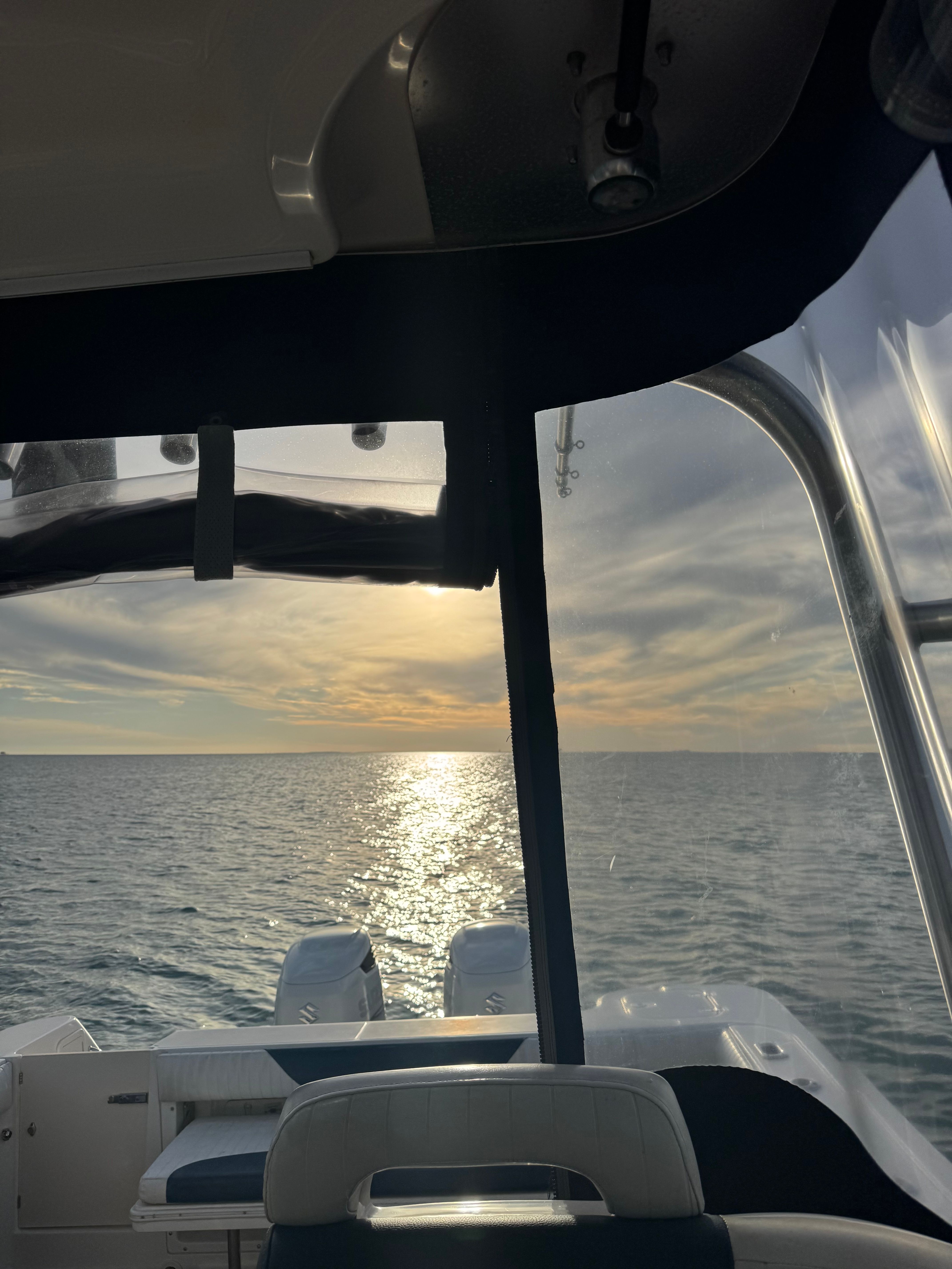 Boston Whaler 305 Conquest 2005 on calm sea at sunset.
