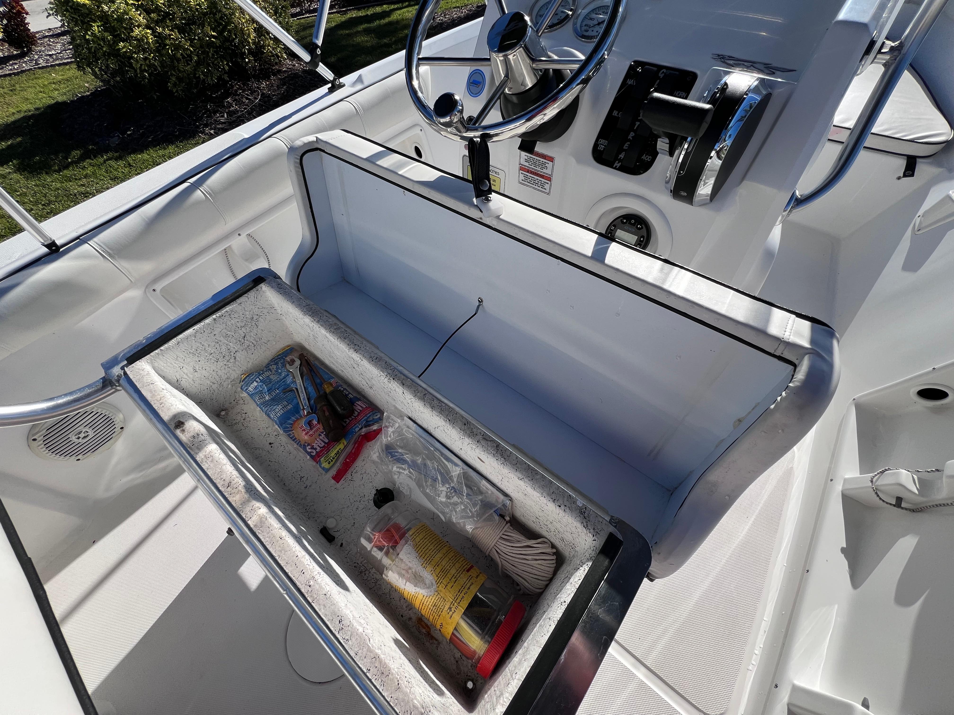 2021 Glasstream 180 CC boat interior with storage compartment open, showcasing various items.