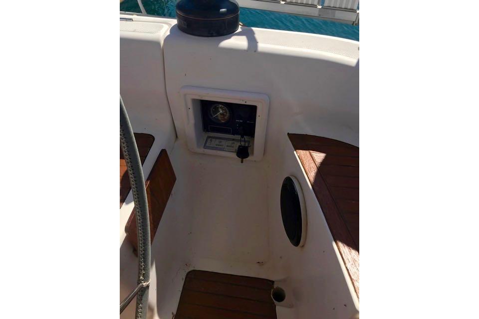 Cockpit of 1998 Dufour 45 Classic sailboat with wooden accents and control panel.