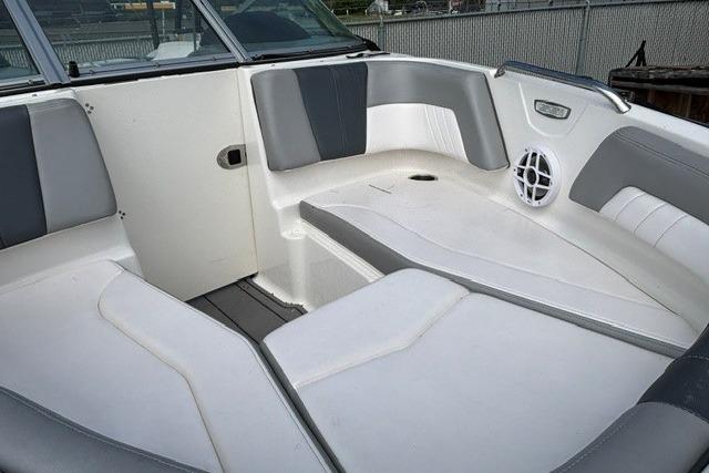 Interior view of a 2021 Chaparral 21 SSi boat with gray and white seating.