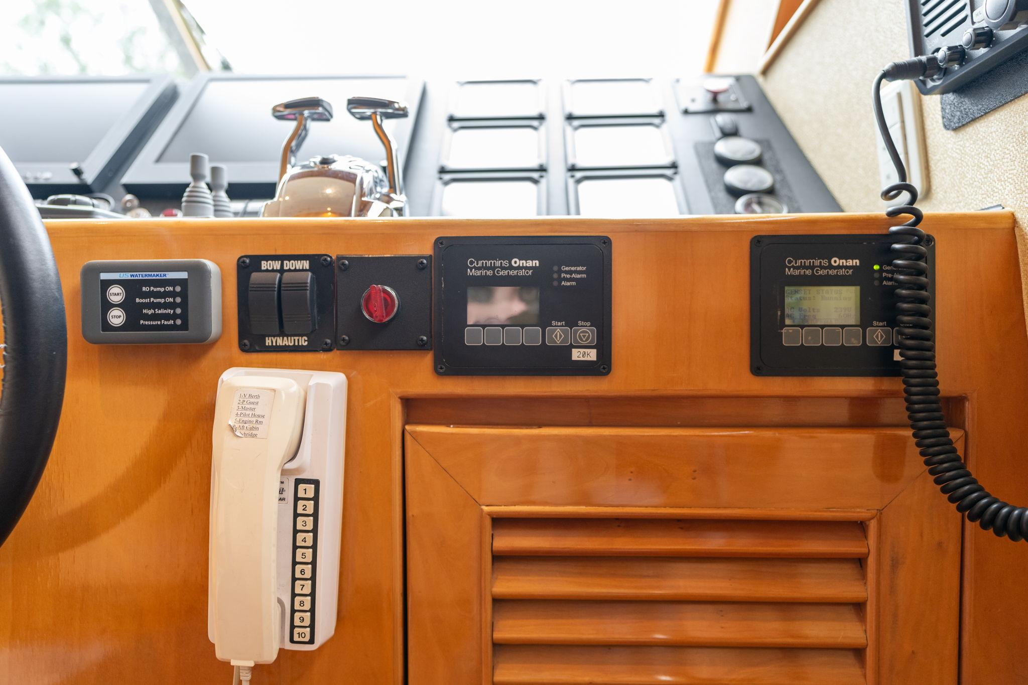 Control panel of 1999 Vitech 68' Pilothouse yacht with communication devices and gauges.
