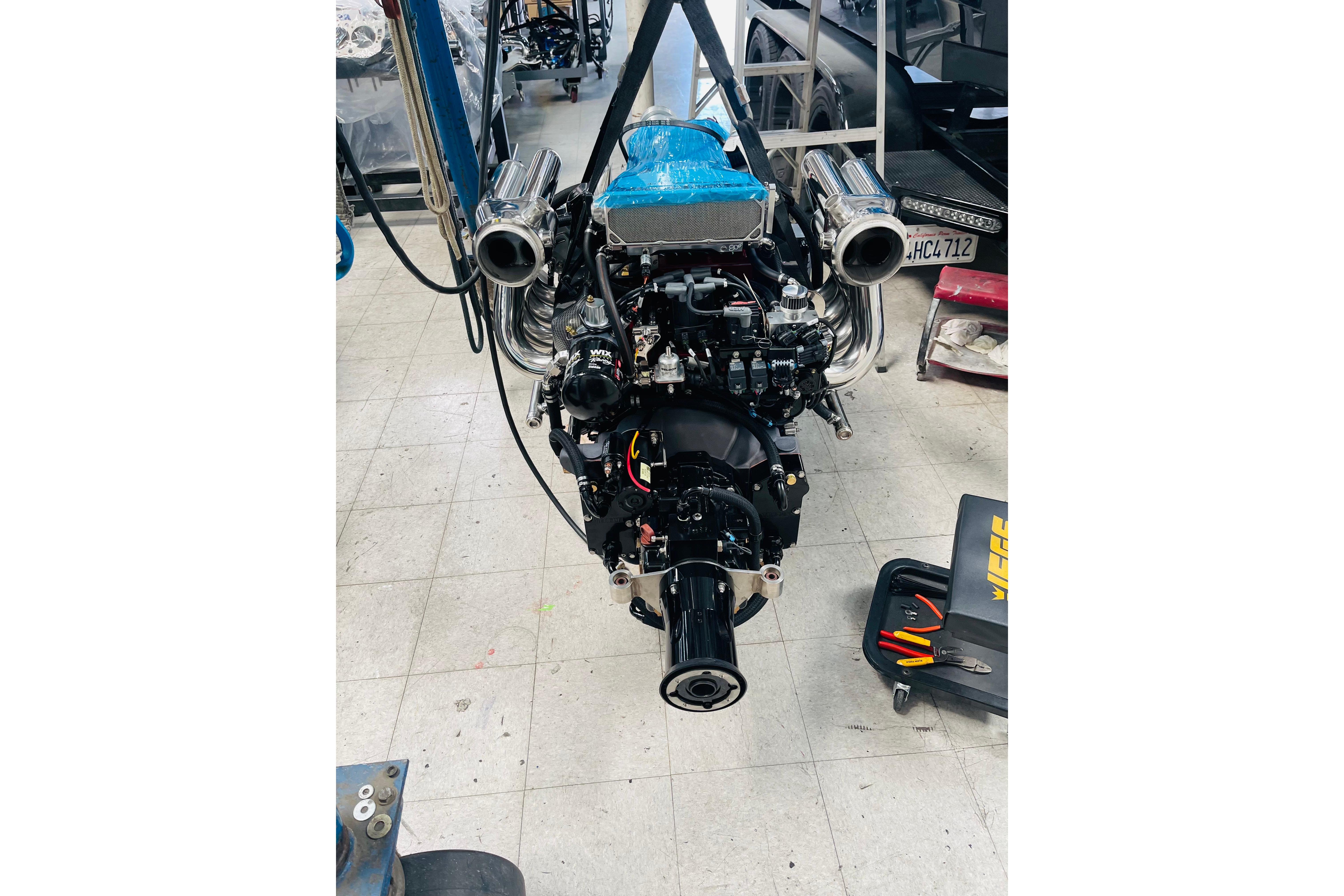 Engine of a 2013 Nordic 39 POKER RUN boat in a workshop setting.