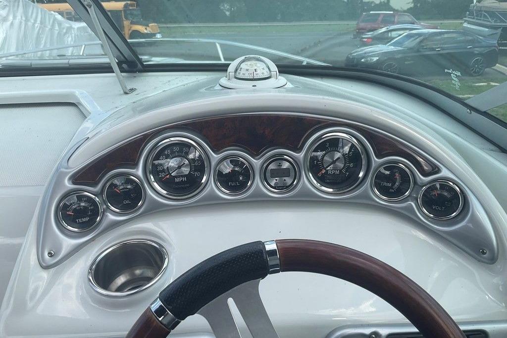 Dashboard of a 2015 Crownline 236 SC boat with gauges and steering wheel.