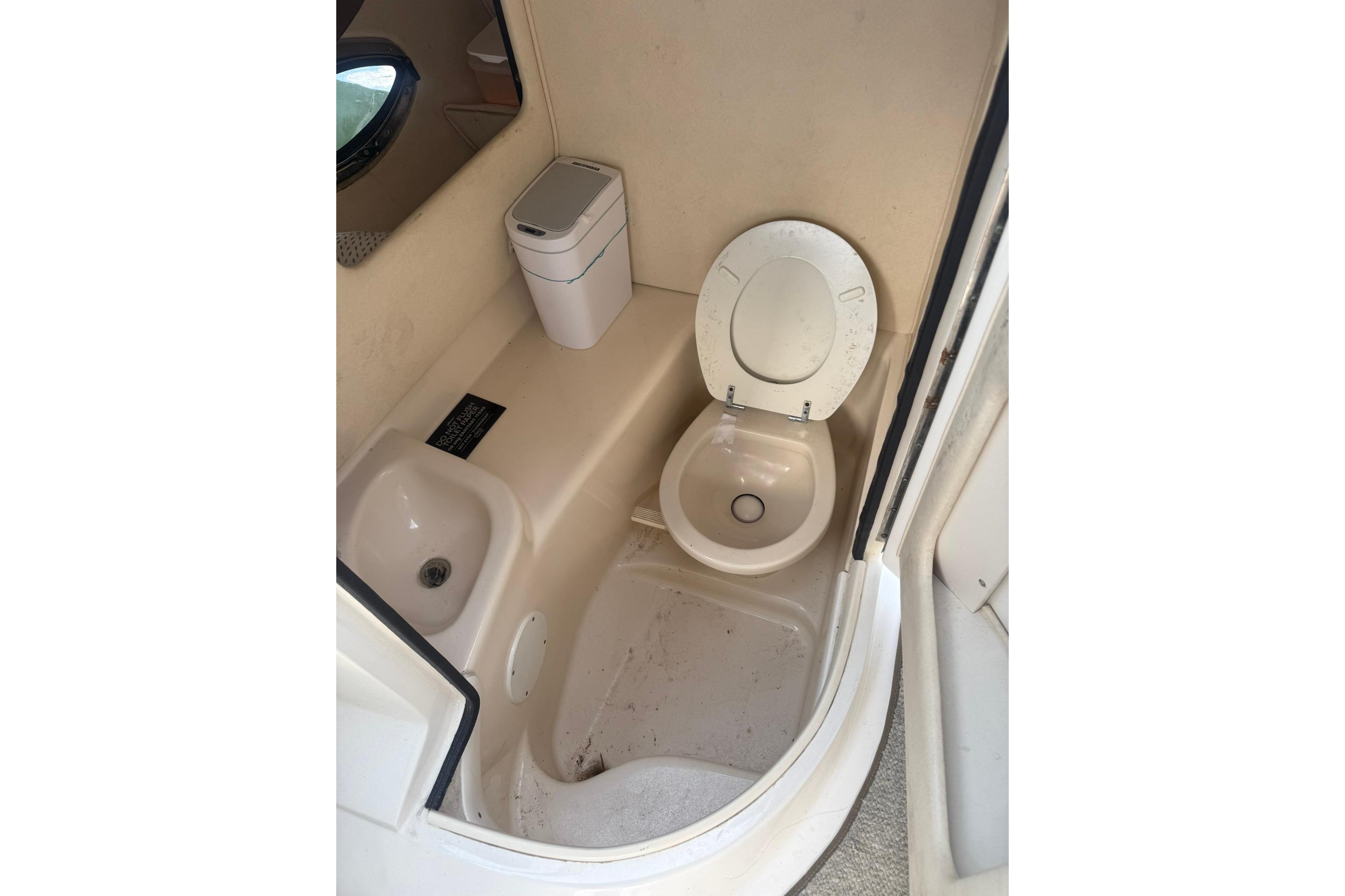 2005 Sea Ray 290 SLX boat bathroom with toilet and sink.