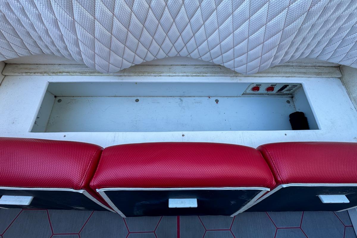 Red and white seating with storage compartment in 2022 Velocity 290sc boat.