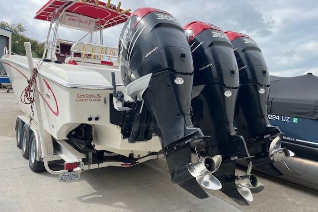 2001 Fountain 38 Center Console boat with triple 300 horsepower outboard engines on a trailer.