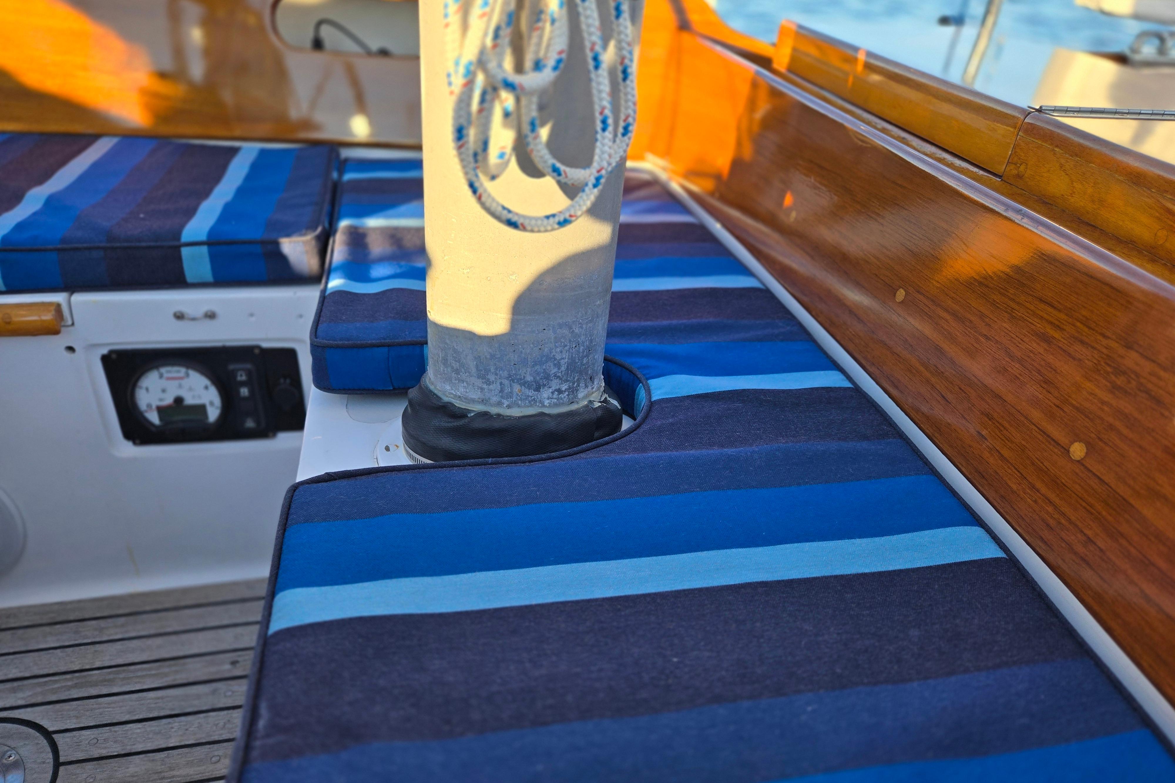 Hinckley Bermuda 40 sailboat interior with striped cushions and wooden trim, 1970 model.
