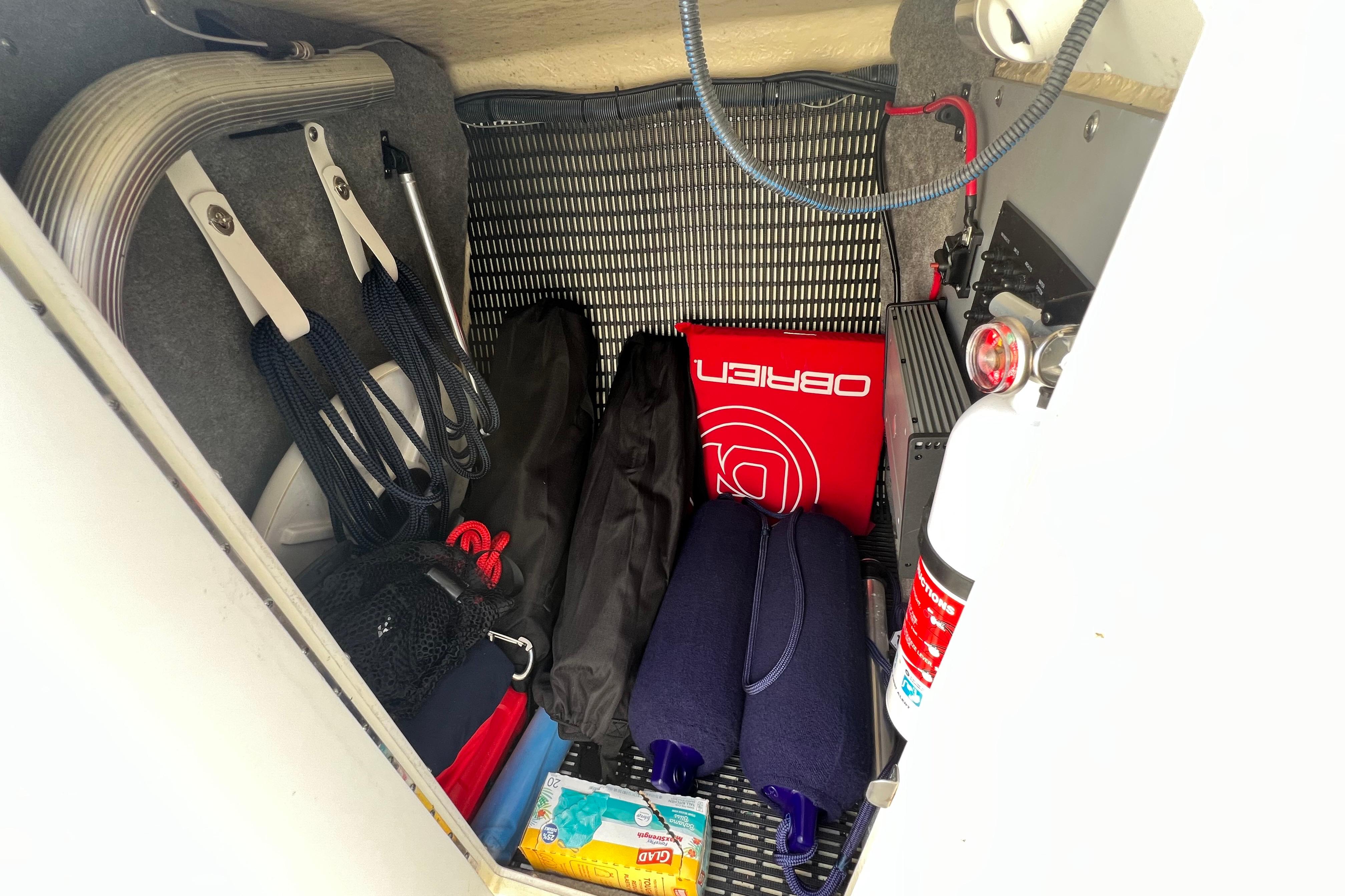 Storage compartment of a 2015 Monterey 268SS Super Sport boat with safety equipment.