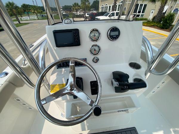2024 Key West 203 FS boat console with steering wheel and gauges.