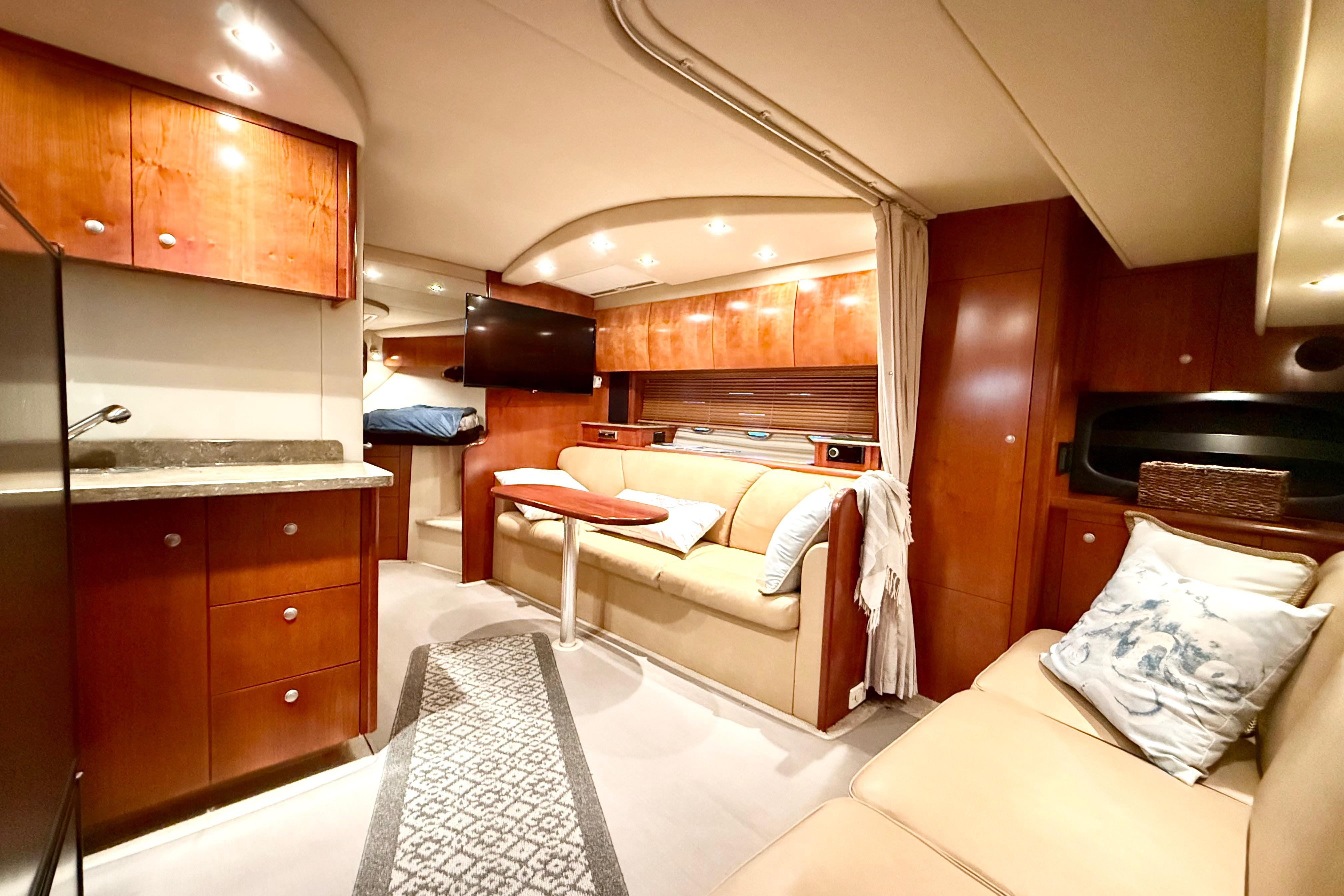 Luxurious interior of 2011 Cruisers Yachts 390 Sports Coupe with elegant wood finishes.