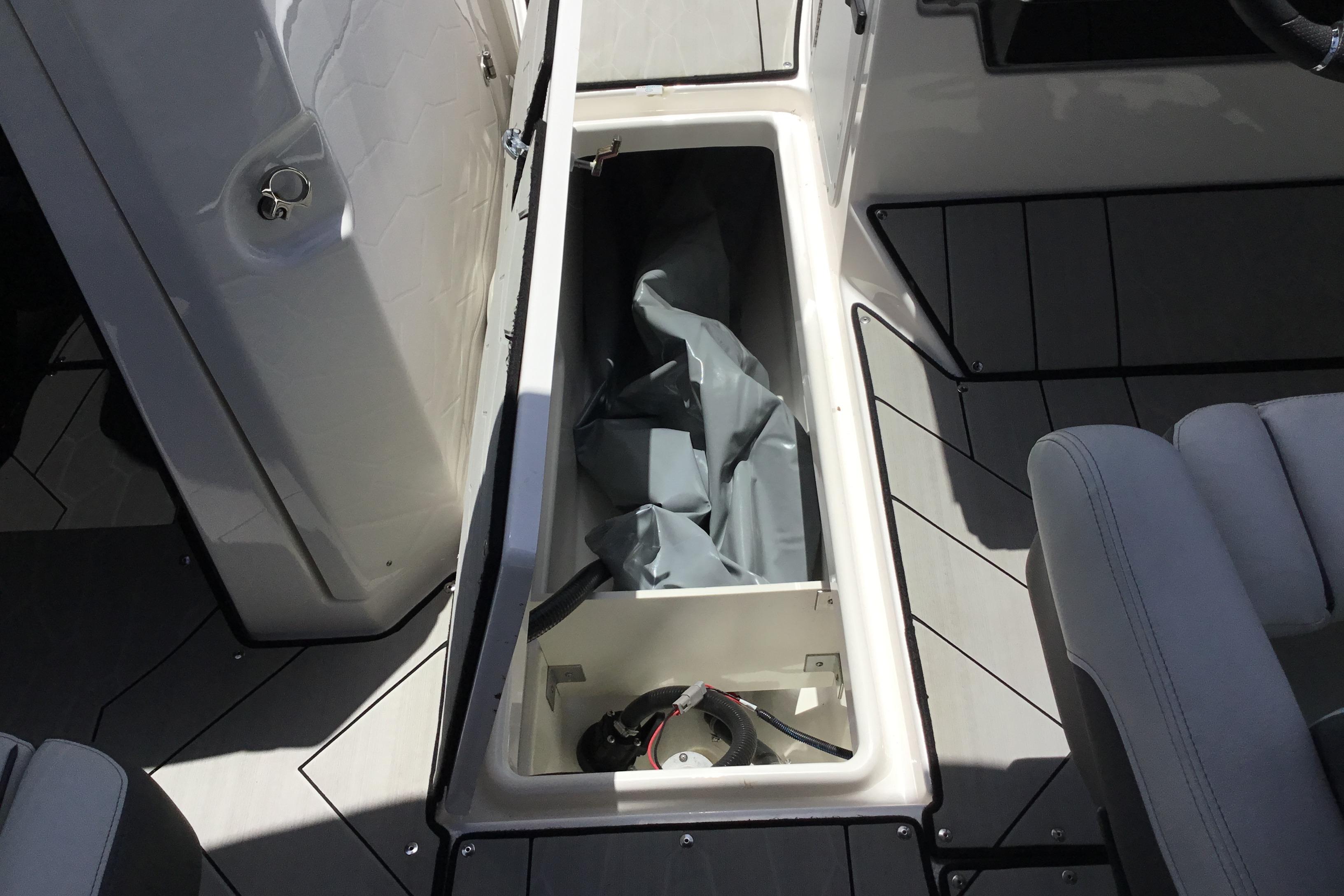 2023 Yamaha Boats 252XE storage compartment with open hatch, showcasing interior space.