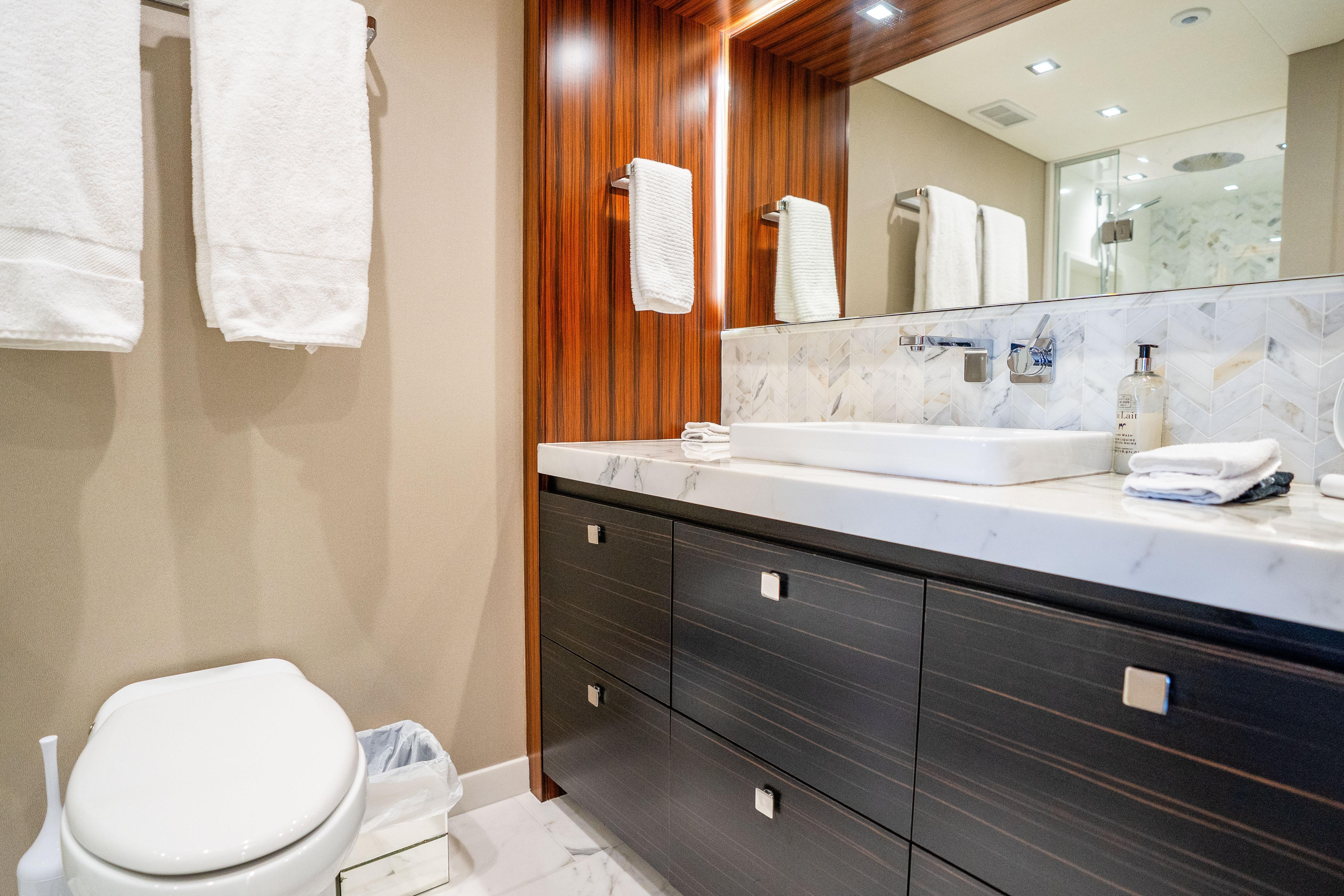 Luxurious bathroom in 2021 Hatteras M75 Panacera yacht with modern fixtures and elegant design.
