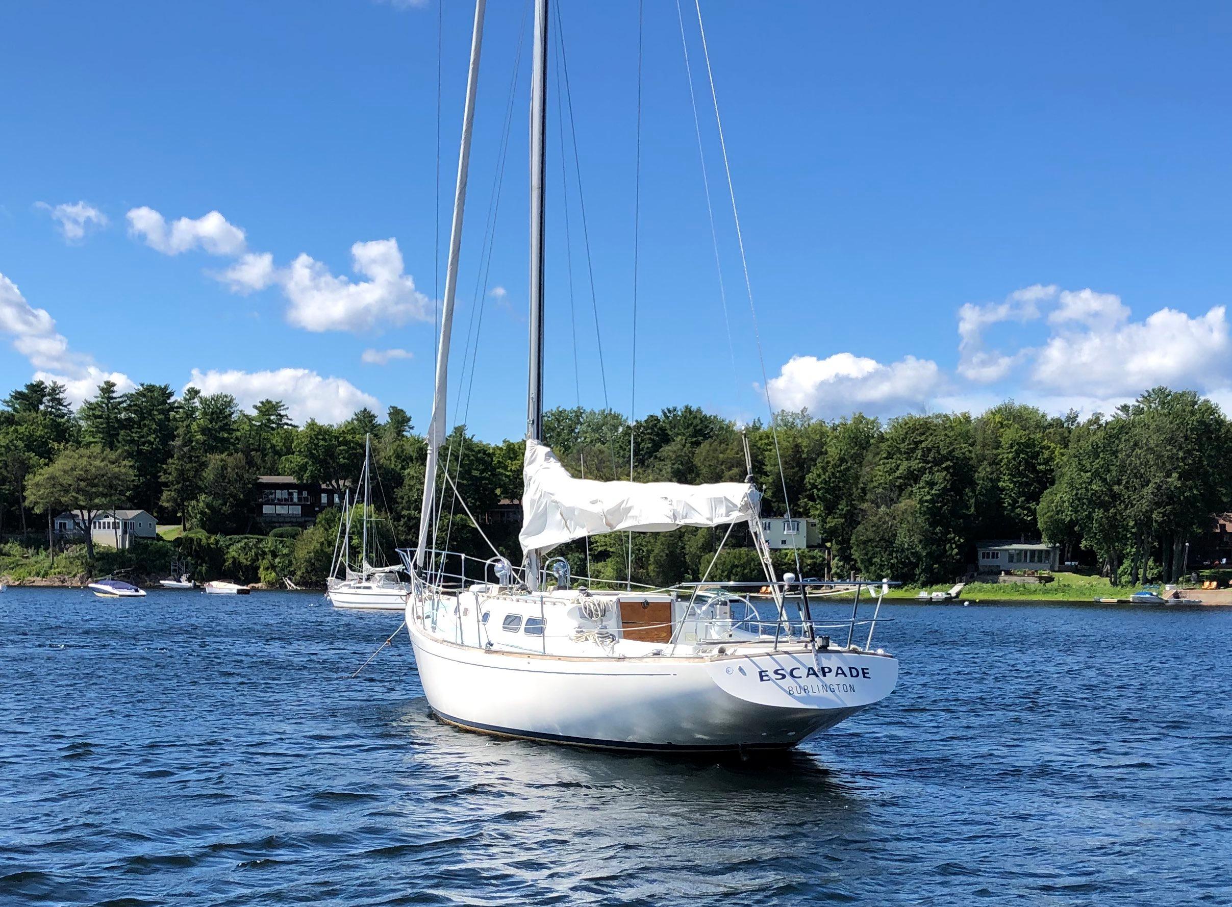 1971 Morgan 42 sailboat anchored on a tranquil lake.
