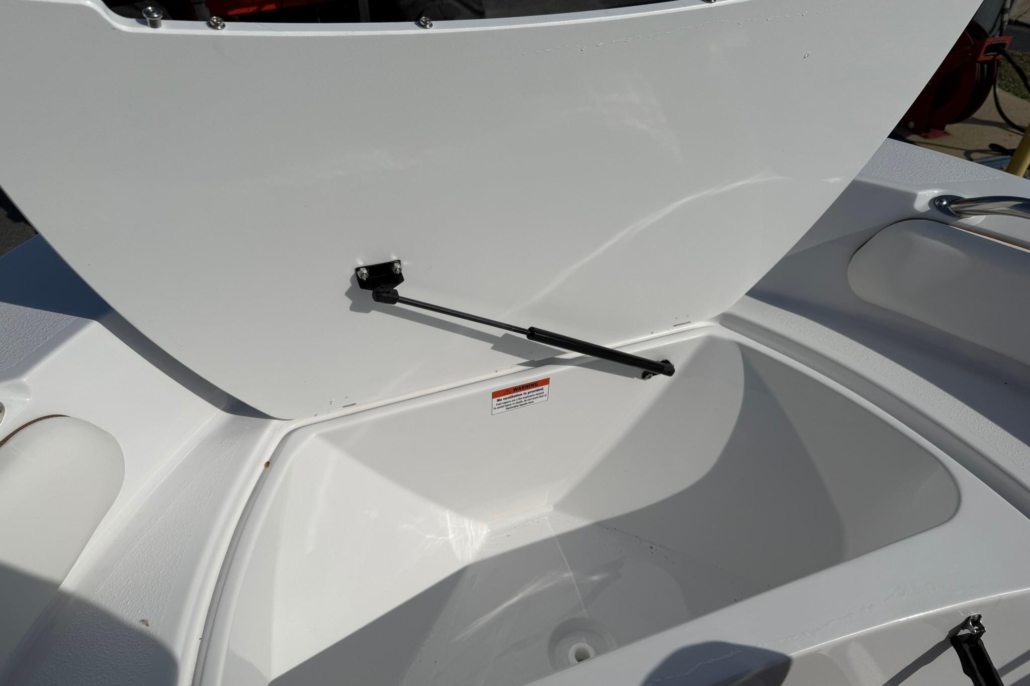 Open storage compartment on 2026 Stingray 173 CC boat, showcasing interior space.