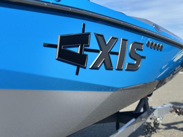 2025 Axis A225 boat, blue exterior, close-up of logo on hull.