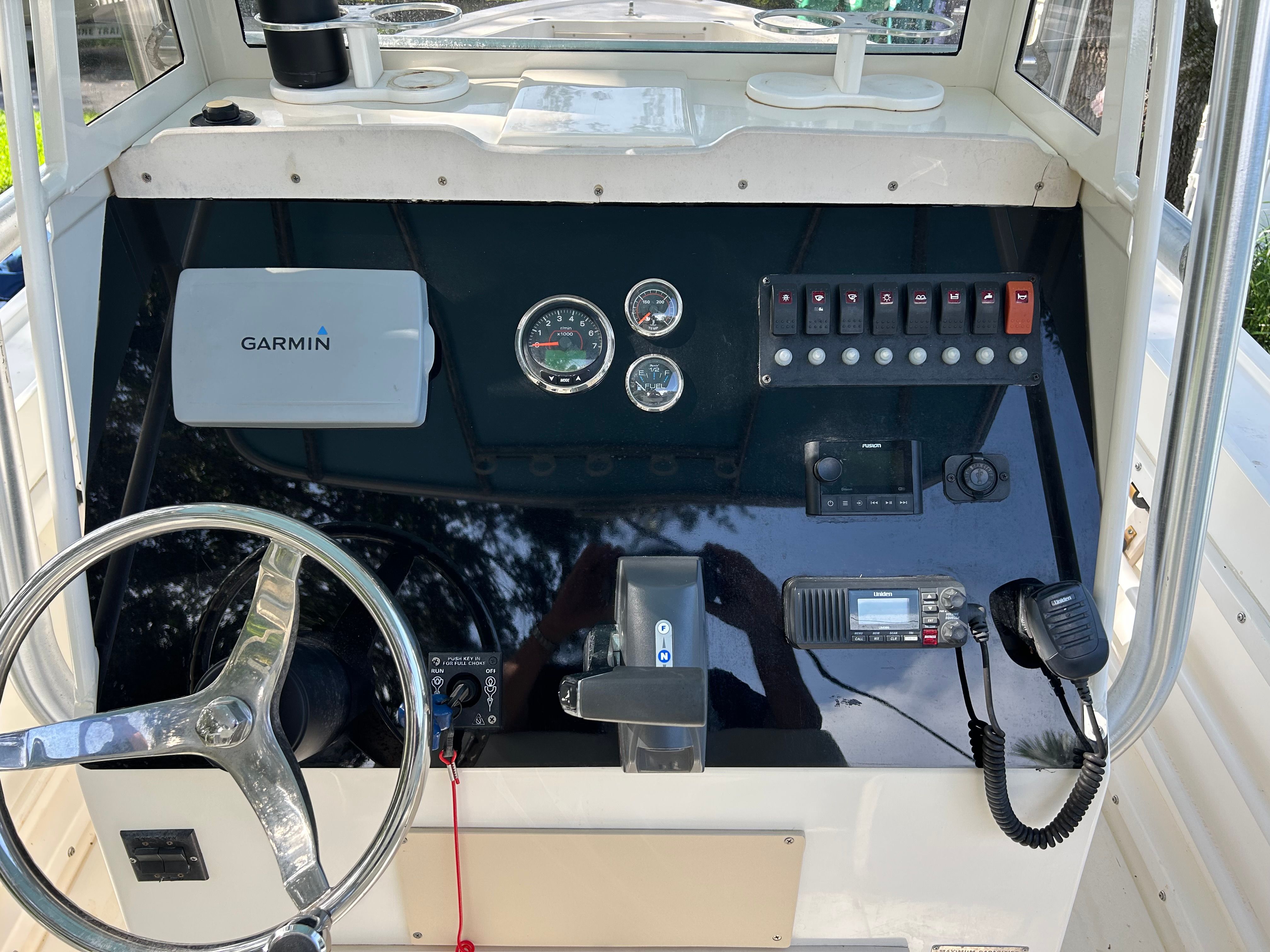 Dashboard of a 1992 Mako 221 boat with Garmin device.