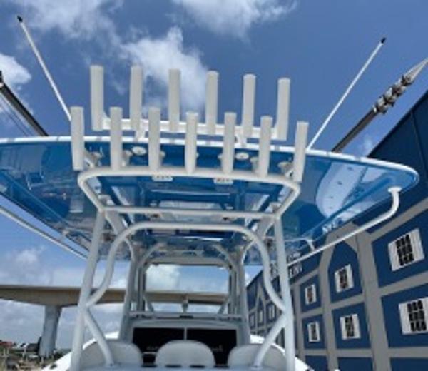 2022 Yellowfin 39 Offshore boat with blue canopy and rod holders, under a clear sky.