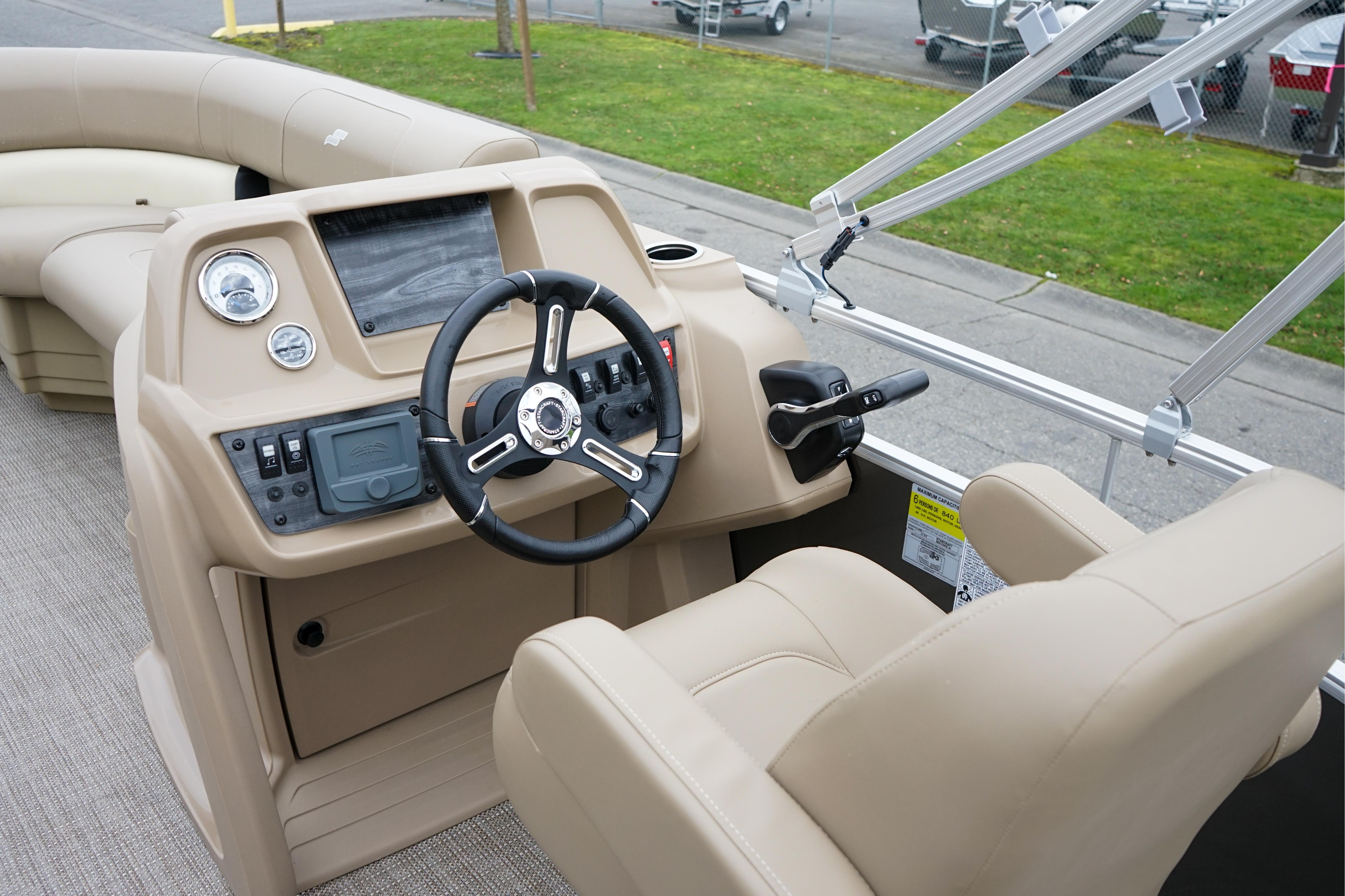 Interior of 2025 Starcraft LX16R boat with steering wheel and control panel.