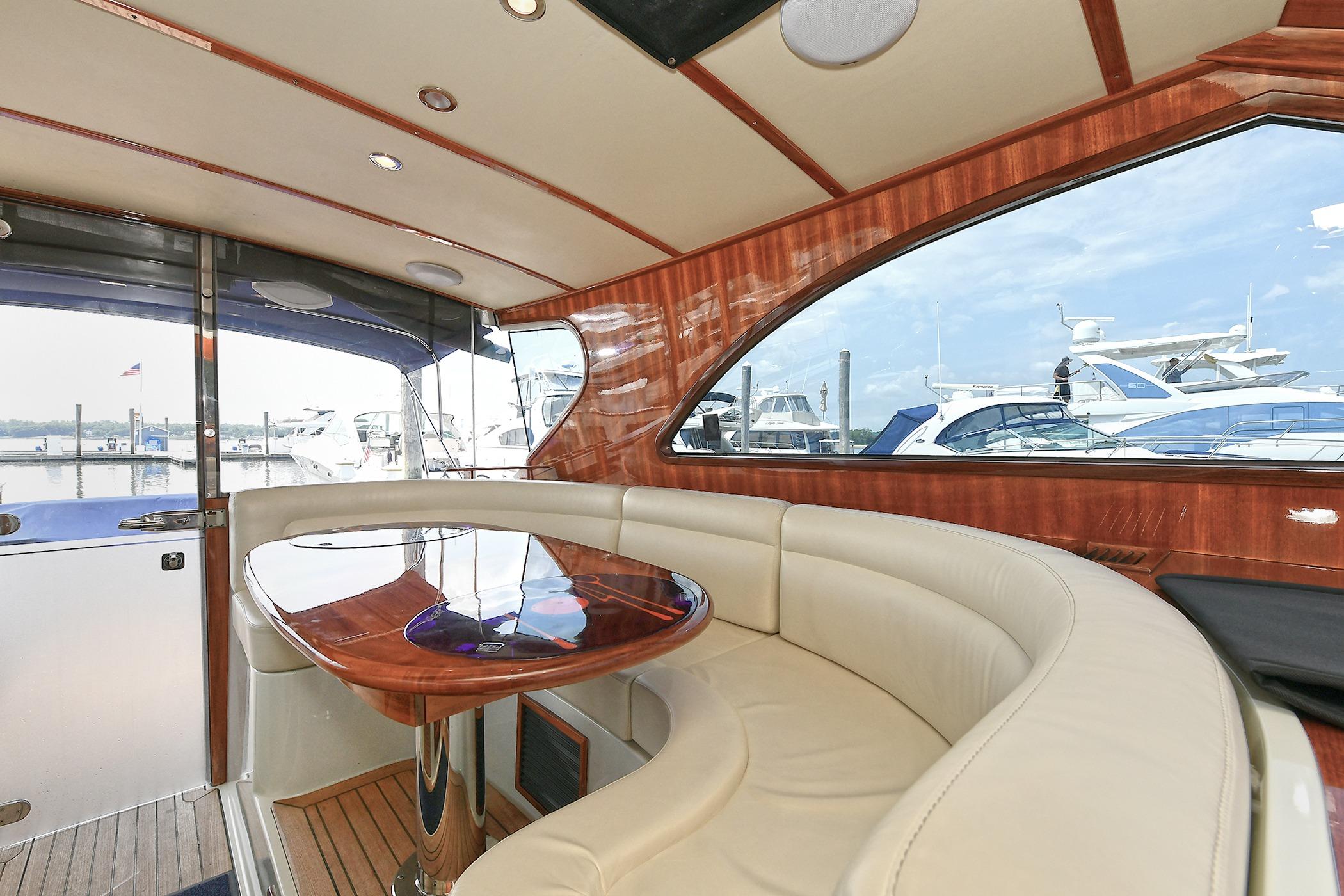 Luxurious 2005 San Juan Downeast Express yacht interior with elegant wood and leather seating.