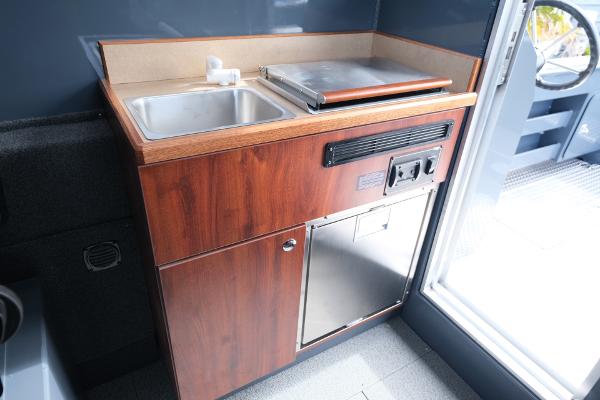 2024 Hewescraft 250 Explorer interior kitchenette with sink and stove.