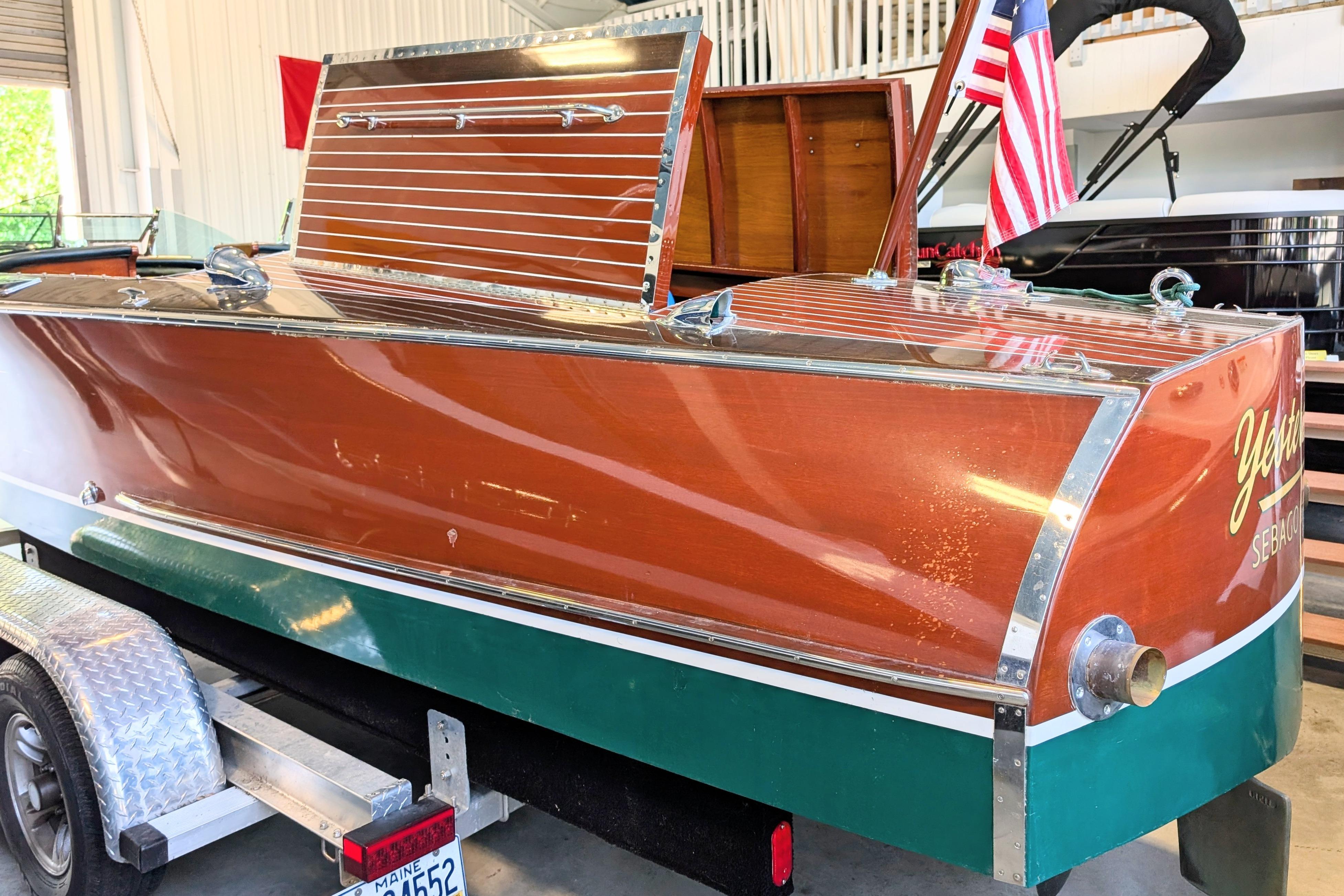 Vintage 2001 Hacker-Craft 24 Dual Console boat on trailer, showcasing classic wooden design.