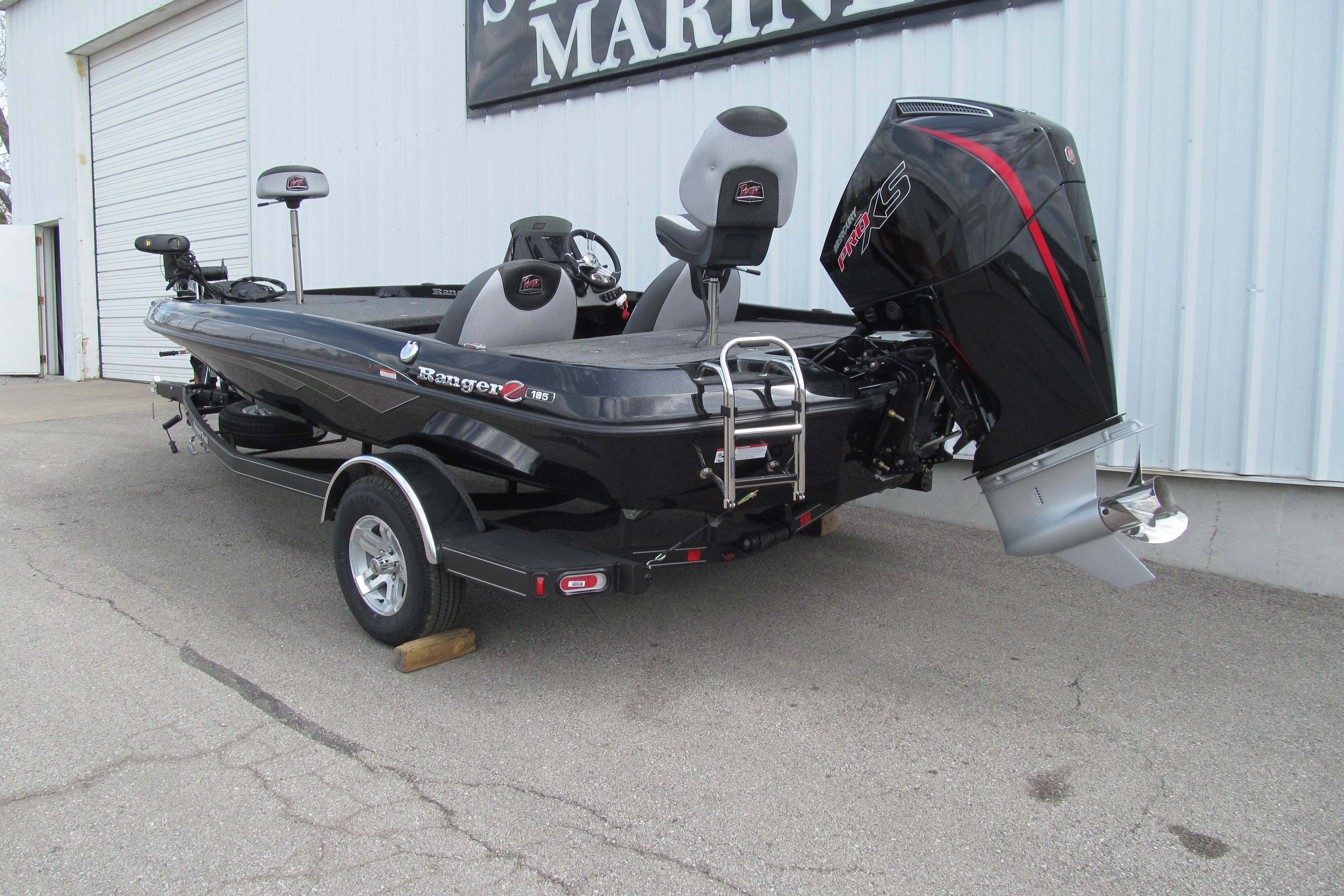 2026 Ranger Z185 boat with powerful outboard motor, parked outside a marine shop.