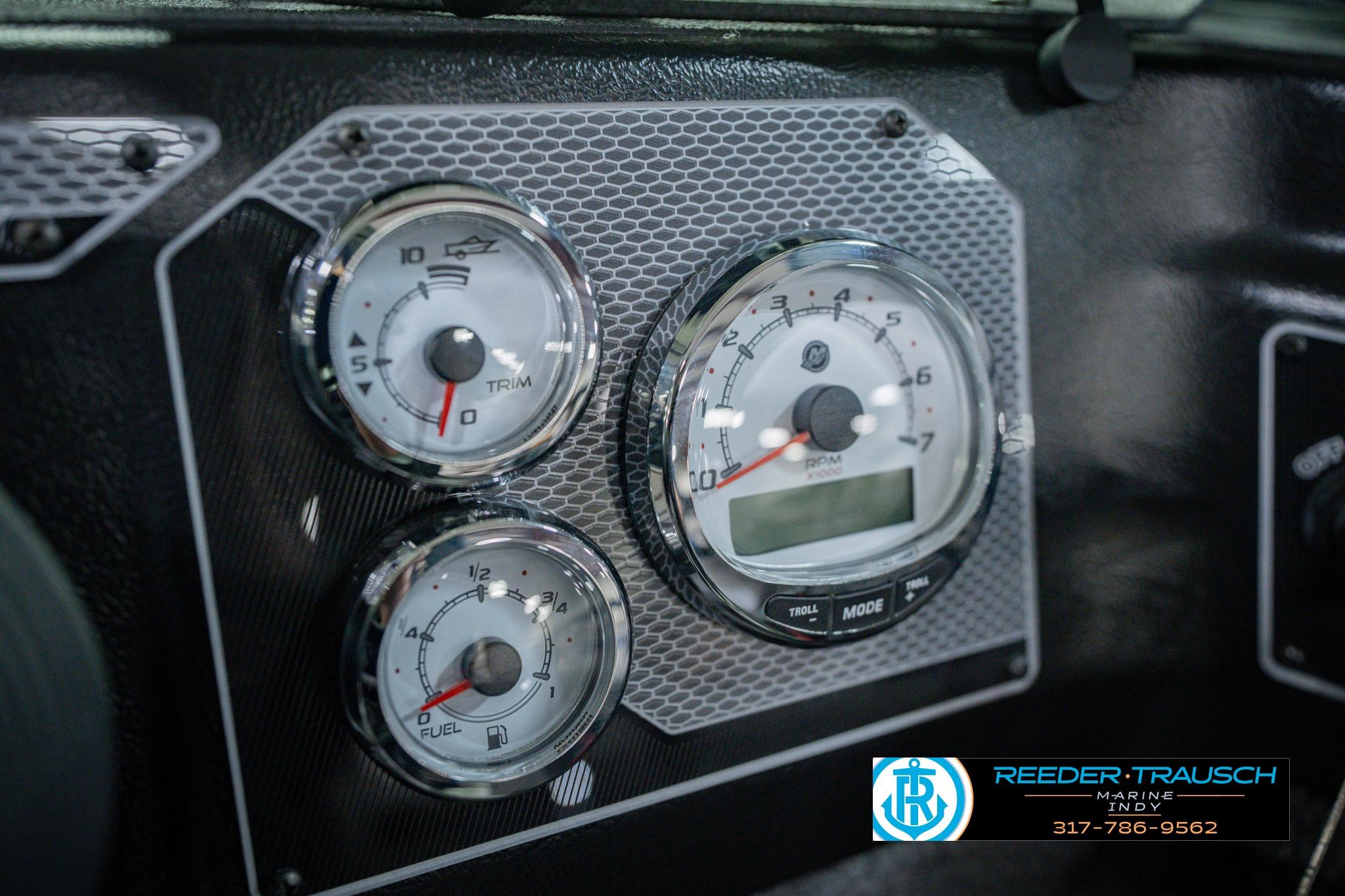 Dashboard gauges of 2026 Lund 1775 Impact XS boat, featuring trim and fuel indicators.